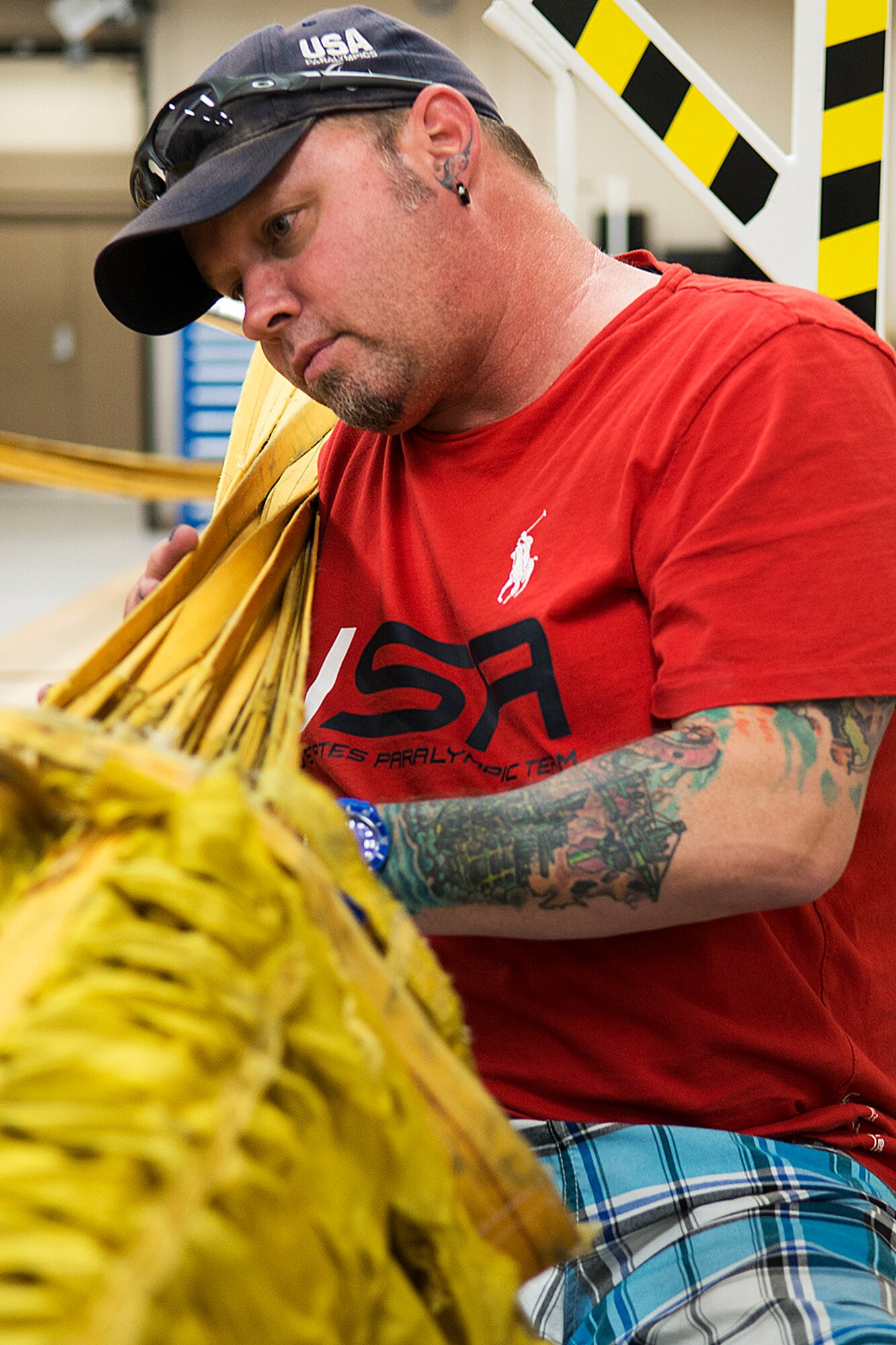 Patrick McDonald, U.S. Paralympic Curling Team captain, helps repack a B-52H Stratofortress drag chute during a tour of the 307th Operations Support Flight aircrew flight equipment shot, June 4, 2014, Barksdale Air Force Base, La. McDonald is part of the American300 Tours, which visits military installations with the goal of increasing resiliency of the troops, their families, and the communities that they live and operate in. (U.S. Air Force photo by Master Sgt. Greg Steele/Released)