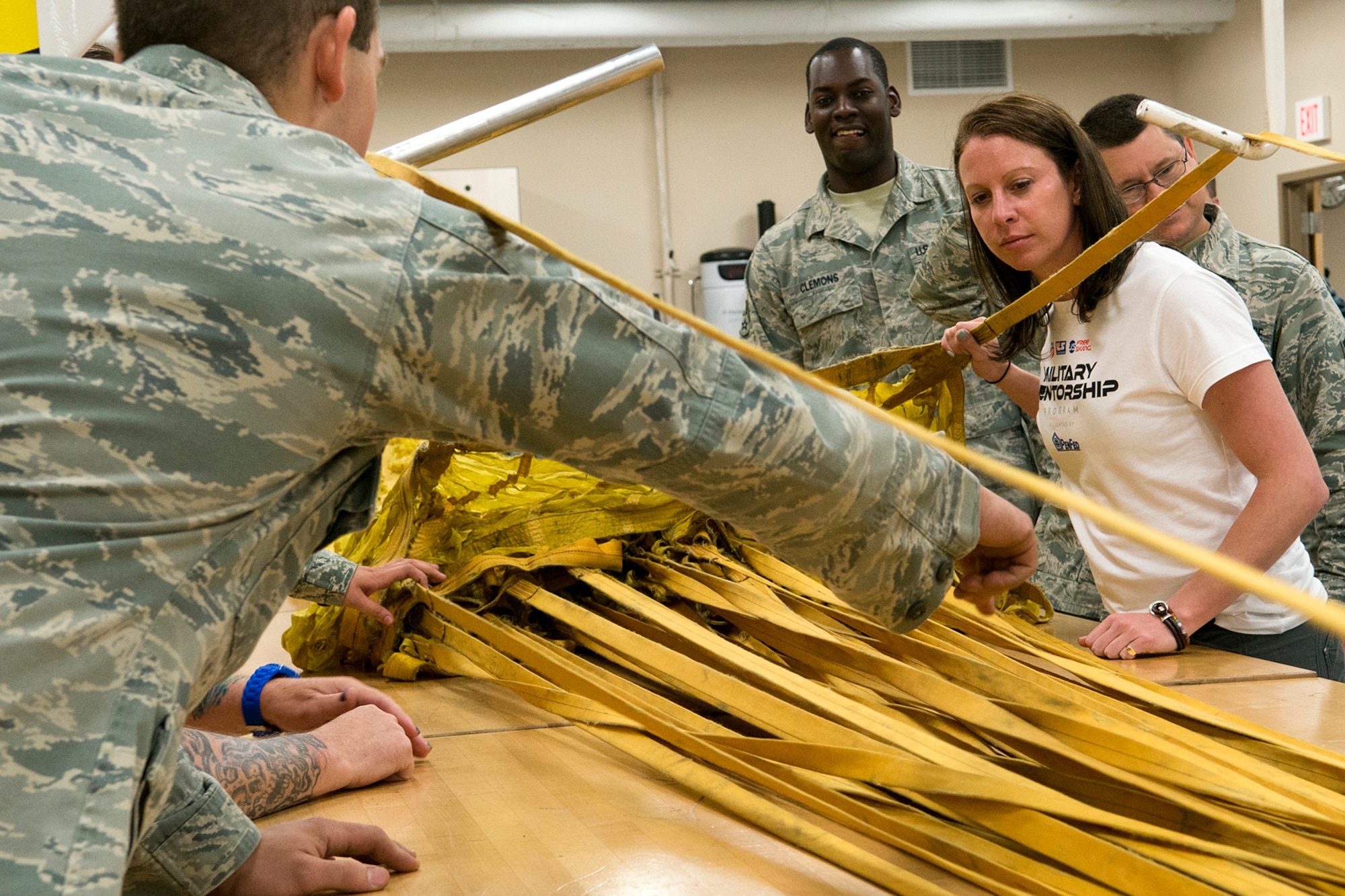 Emily Cook, 3-time Olympian U.S. Freestyle skier, gets instructed on how to pack a B-52H Stratofortress drag chute during a tour of the 307th Operations Support Flight aircrew flight equipment shot, June 4, 2014, Barksdale Air Force Base, La. Cook is part of the American300 Tours, which visits military installations with the goal of increasing resiliency of the troops, their families, and the communities that they live and operate in. (U.S. Air Force photo by Master Sgt. Greg Steele/Released)
