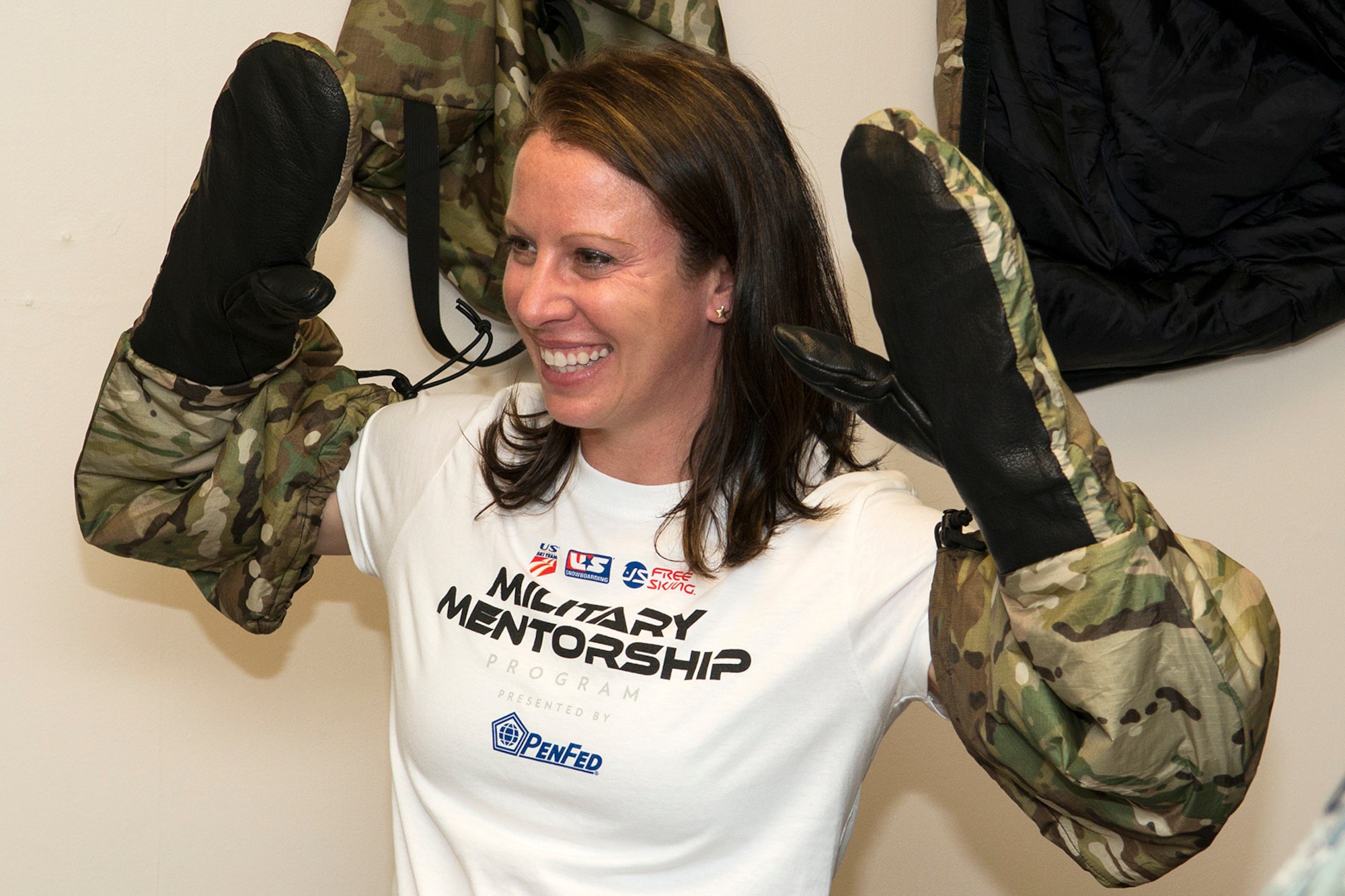 Emily Cook, 3-time Olympian U.S. Freestyle skier, tries on cold weather survival gear during a tour of the 307th Operations Support Flight aircrew flight equipment shot, June 4, 2014, Barksdale Air Force Base, La. Cook is part of the American300 Tours, which visits military installations with the goal of increasing resiliency of the troops, their families, and the communities that they live and operate in. (U.S. Air Force photo by Master Sgt. Greg Steele/Released)