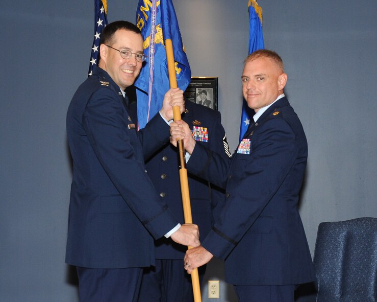 Col. Christopher Holmes, the 325th Mission Support Group commander, passes the 325th Force Support Squadron guidon to Lt. Col. Johnathan Zulauf, 325th FSS commander, during a change of command ceremony June 6. Zulauf replaces Lt. Col. Kyle Head who will go on to serve as the executive officer to the Secretary of Defense's Representative to Europe/USNATO Defense Advisor at the United States Mission to NATO in Brussels City, Belgium. (U.S. Air Force photo by Airman 1st Class Alex Echols) 
