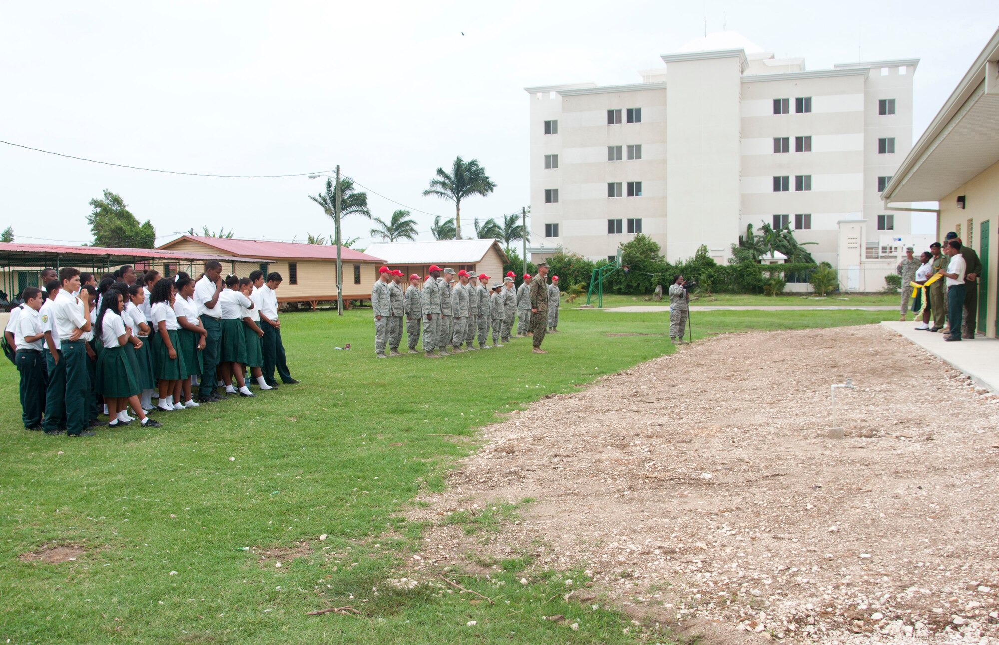 Edward P. Yorke students and teachers and U.S. and Belizean military members listen to remarks by Rodrick Cardinez, E.P. Yorke principal, during the ribbon cutting ceremony June 4, 2014, at the school in Belize City, Belize. The school's 1,372 square foot, two-classroom addition is one of five New Horizons projects in the country. New Horizons is an annual multinational exercise that provides training opportunities in civil engineering and medical care. (U.S. Air Force photo by Tech. Sgt. Kali L. Gradishar/Released)