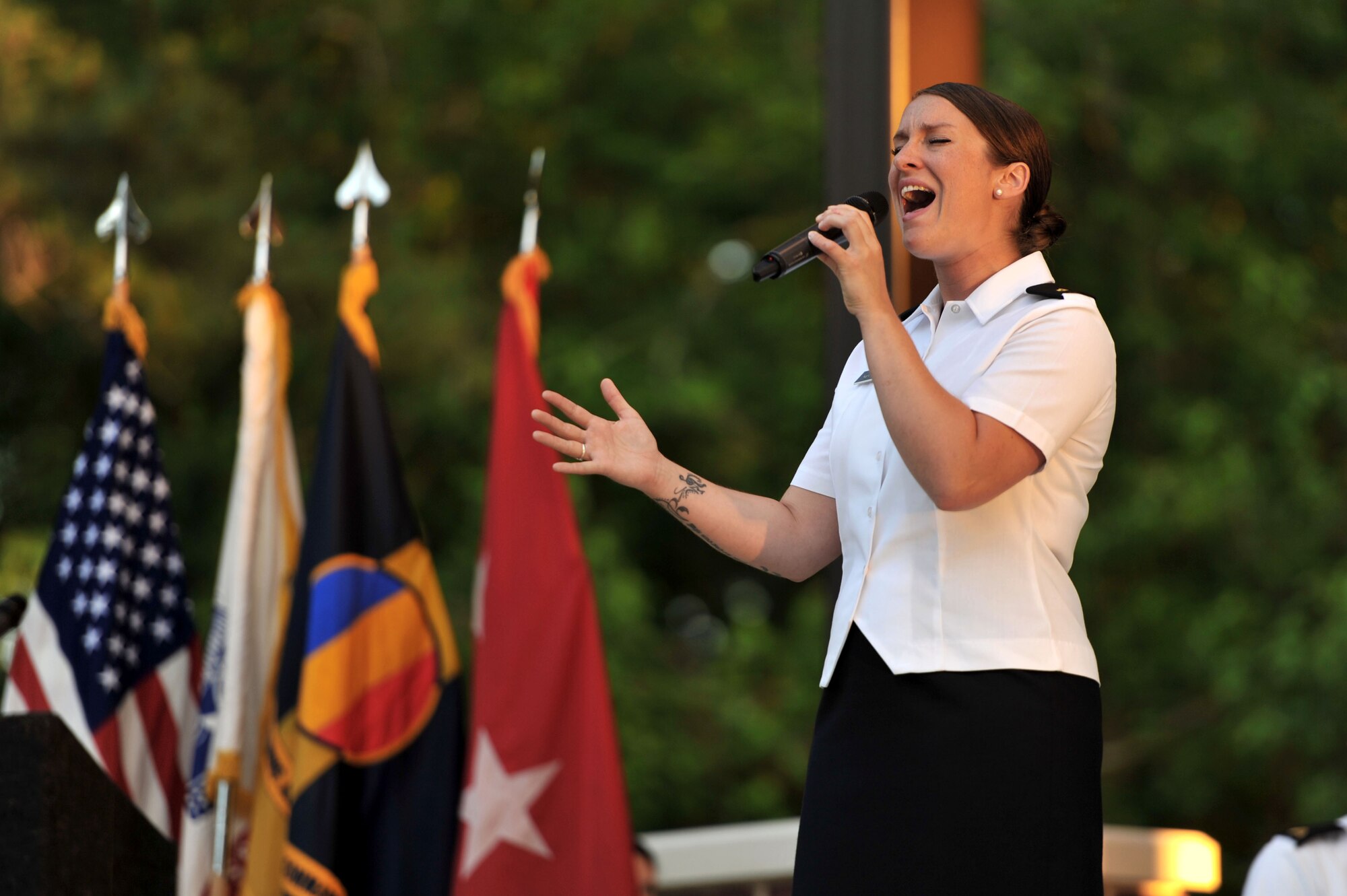 U.S. Army Sgt. Megan Van Oudenaren, Training and Doctrine Command Band vocalist, performs during the TRADOC Band’s Music Under the Stars opening concert at Fort Eustis, Va., June 5, 2014.  Van Oudenaren experienced Music Under the Stars for the first time as an Advanced Individual Training student, when the concerts were previously held at Fort Monroe, Va.  (U.S. Air Force photo by Staff Sgt. Katie Gar Ward/Released)