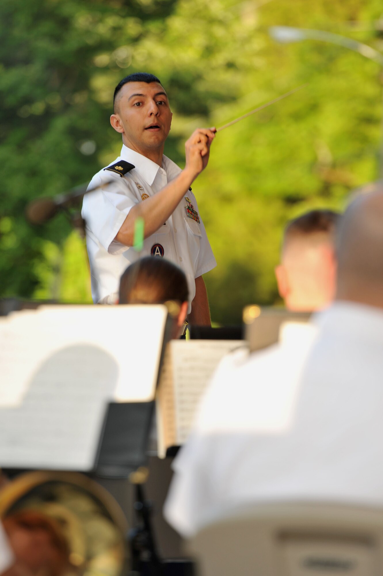 U.S. Army Maj. Leonel Peña, Training and Doctrine Command Band commander, conducts during the opening concert of the Music Under the Stars summer concert series at Fort Eustis, Va., June 5, 2014. The next in the series is the Army Birthday concert, scheduled for June 12, and will feature a streamer ceremony for the Army flag and an enlistment ceremony for 70 future Soldiers. (U.S. Air Force photo by Staff Sgt. Katie Gar Ward/Released)