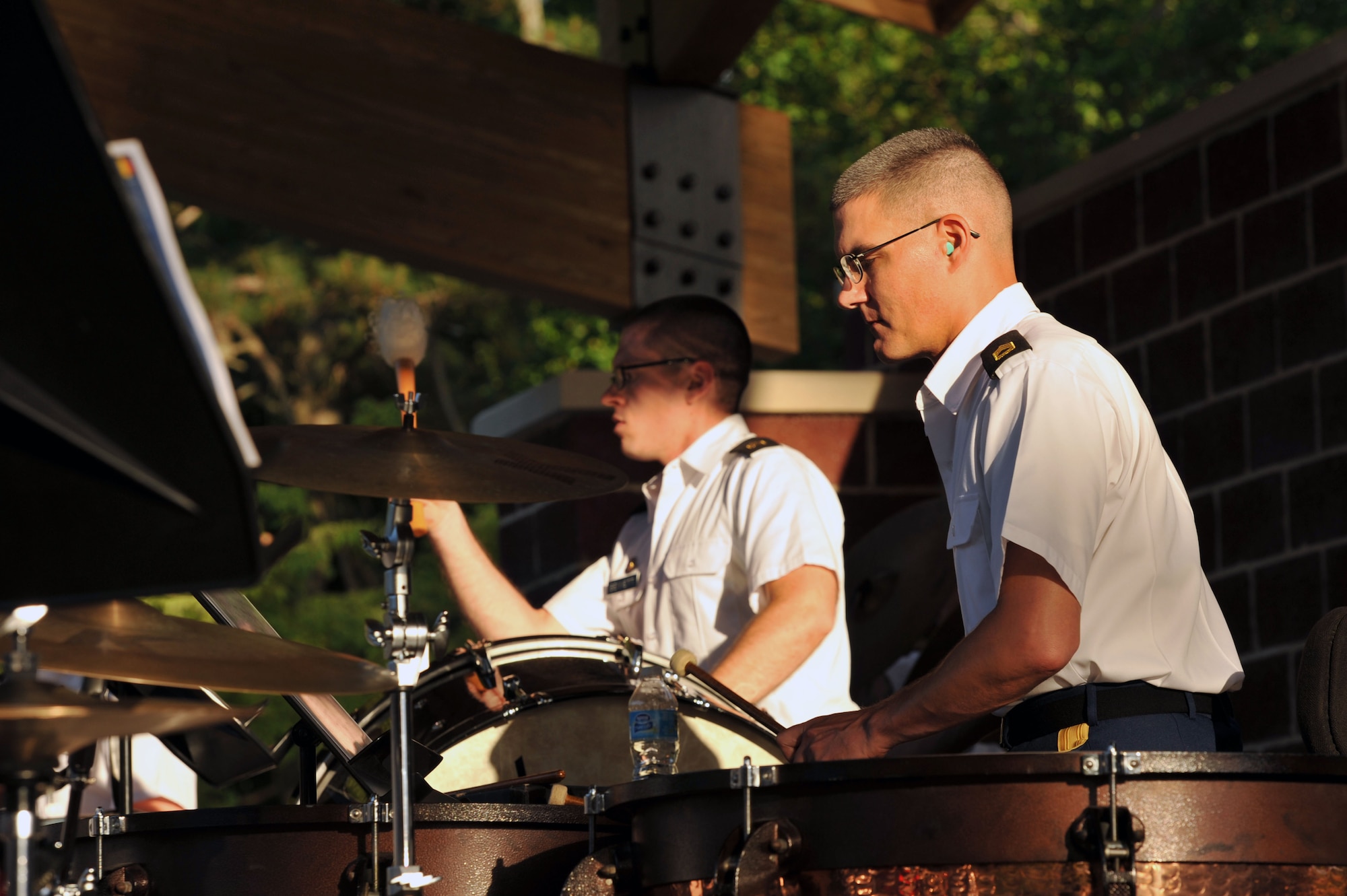 From left, U.S. Army Sgt. Joey Bennett, Training and Doctrine Command band guitarist, and Sgt. 1st Class Randy Hagan, TRADOC band percussionist, perform during the opening concert of the Music Under the Stars summer concert series at Fort Eustis, Va., June 5, 2014. In addition to providing musical entertainment to the community, this season’s concerts will feature food vendors and community information booths. (U.S. Air Force photo by Staff Sgt. Katie Gar Ward/Released)