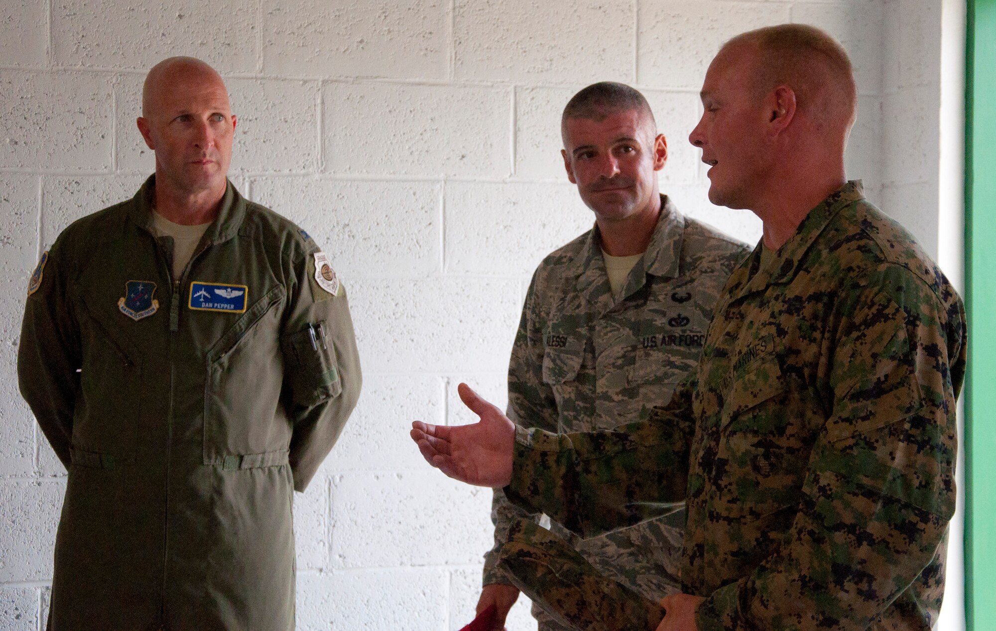 U.S. Marine Corps Staff Sgt. Matt Houle, construction site foreman, right, and U.S. Air Force Master Sgt. Nicholas Alessi, construction site project manager, second from right, explain the intricacies of the school addition's construction to U.S. Air Force Col. Dan Pepper, New Horizons Belize 2014 Task Force commander, as well as the Belize Defence Force commander and Edward P. Yorke school principal following the ribbon cutting ceremony June 4, 2014, at the school in Belize City, Belize. Marines from various Marine Wing Support Squadrons under the 4th Marine Aircraft Wing worked with engineers from the Belize Defence Force, U.S. Air Force and U.S. Army for nearly 40 working days to build the school's 1,372 square foot, two-classroom. New Horizons is an annual multinational exercise that provides training opportunities in civil engineering and medical care. (U.S. Air Force photo by Tech. Sgt. Kali L. Gradishar/Released)