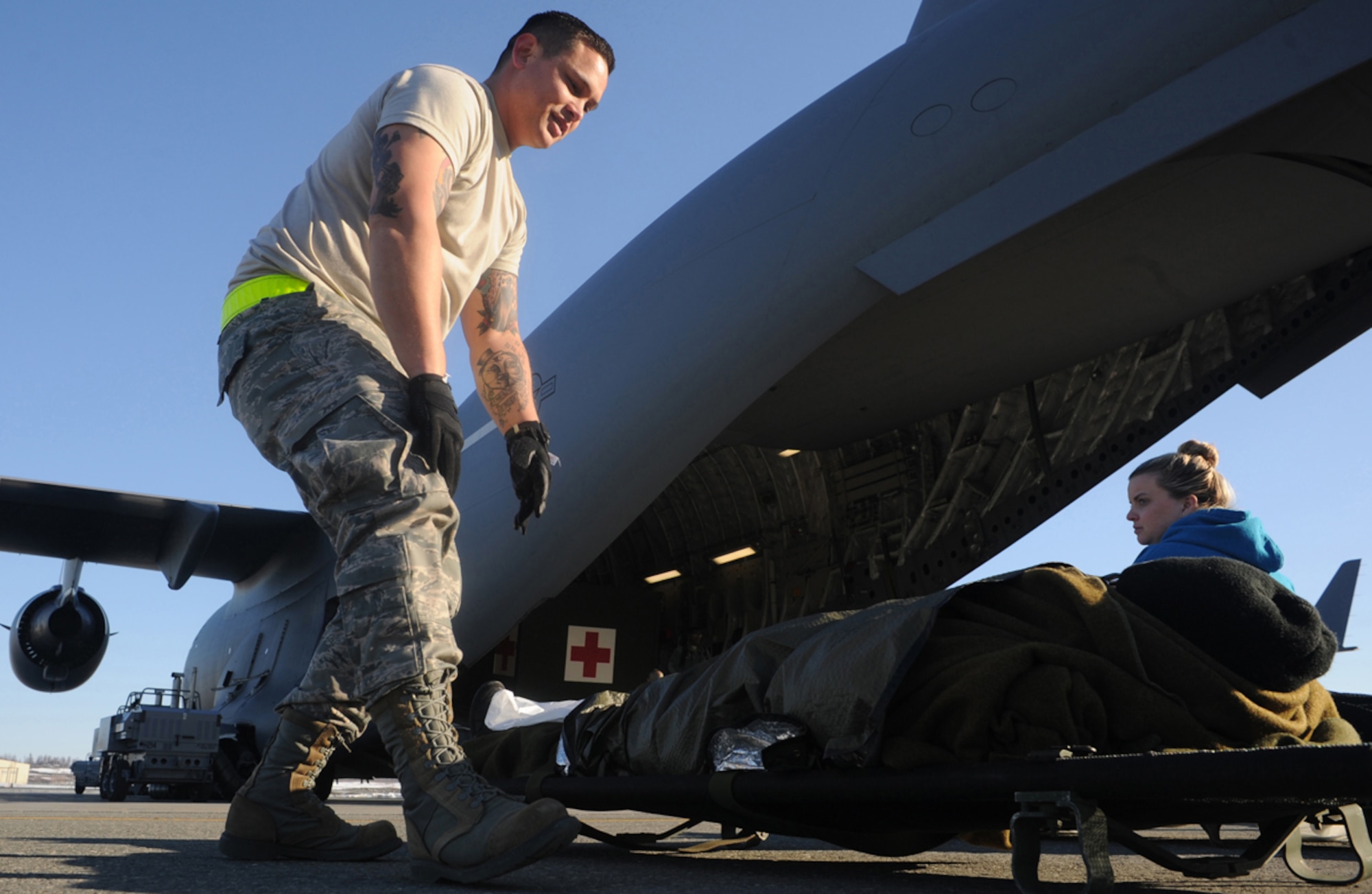 Staff Sgt. Jason Adrian, 60th Medical Group, checks the status of a simulated natural disater casualty during an evacuation drill as part of a mission-assurance exercise in March at Joint Base Elmendorf-Richardson, Alaska, March 31. MAE is a JBER exercise testing the base's ability to survive, operate, and coordinate during a major national disaster.