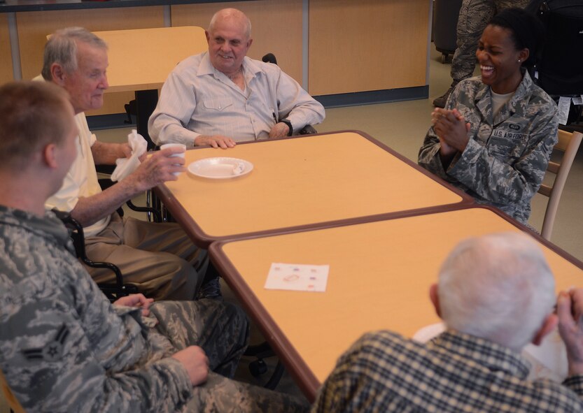 Airman 1st Class Brittanie Langford, 26th Operational Weather Squadron and F4AA vice president, and Airman 1st Class Andrew Holt, 26th OWS and F4AA event coordinator, laugh with Veterans at the North West Louisiana Veterans Home in Bossier City, La., May 29, 2014. (U.S. Air Force photo/Staff Sgt. Amber Corcoran)