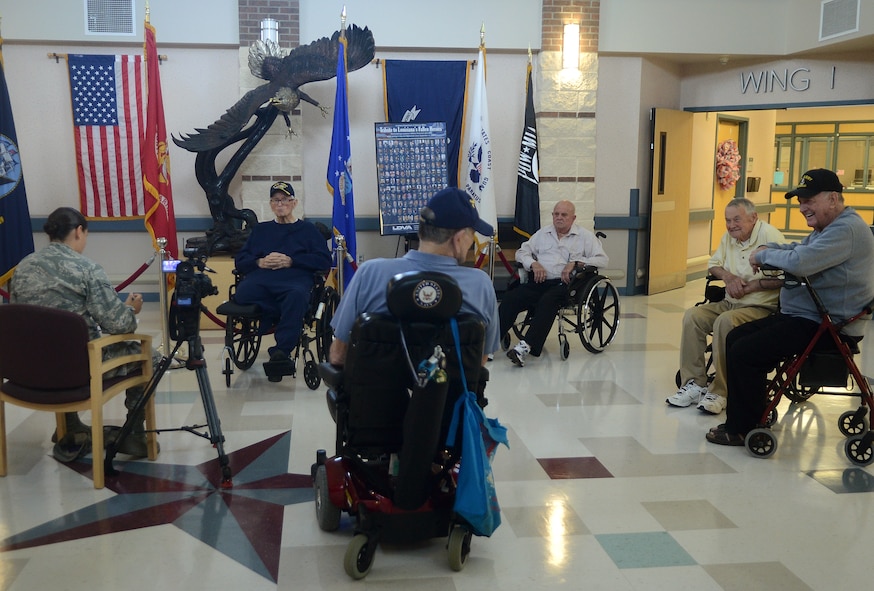 Several Veterans talk amongst themselves while Airman 1st Class Shelby Matullo, 2nd Bomb Wing Public Affairs, interviews Retired Maj. Oddis “Whit” Whittington at the North West Louisiana Veterans Home in Bossier City, La., May 29, 2014. (U.S. Air Force photo/Staff Sgt. Amber Corcoran)