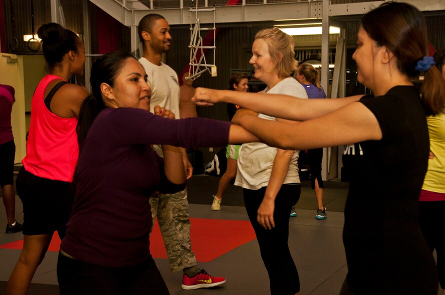 Tech. Sgt. Terence Graden, 571st Mobility Support Advisory Squadron, supervisors a group’s attack and defense drill May 30 during the self-protection seminar. (U.S. Air Force photo/Senior Airman Madelyn Brown)