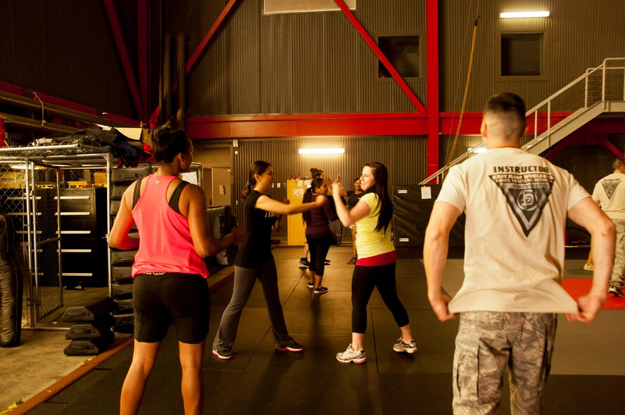 Tech. Sgt. Brandon McPherson supervises a punching attack and defense drill May 30 during the self-protection seminar. (U.S. Air Force photo/Senior Airman Madelyn Brown)