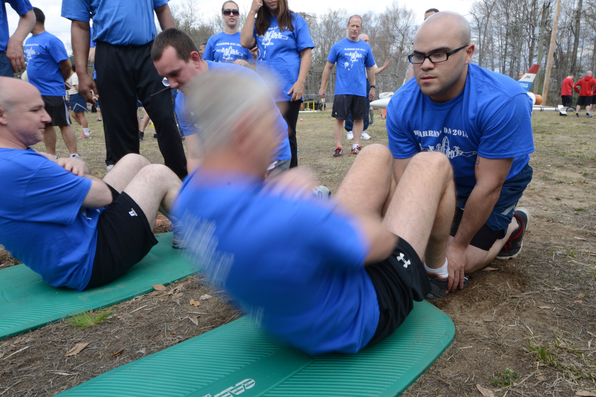 Senior Airman Emmanuel Santiago, 103rd Public Affairs photo journalist, holds the feet of Lt. Col. James Guerrera, executive officer with the 103rd Airlift Wing, as he tries to get as many sit-ups accomplished as he can during the second annual Yankee Warrior Day. The event which was held on May 3, 2014, at the Bradley Air National Guard Base, East Granby, Conn., allowed Airmen an opportunity to compete against each other during various events for a chance at winning a trophy. (U.S. Air Force photo by Tech. Sgt. Joshua Mead)