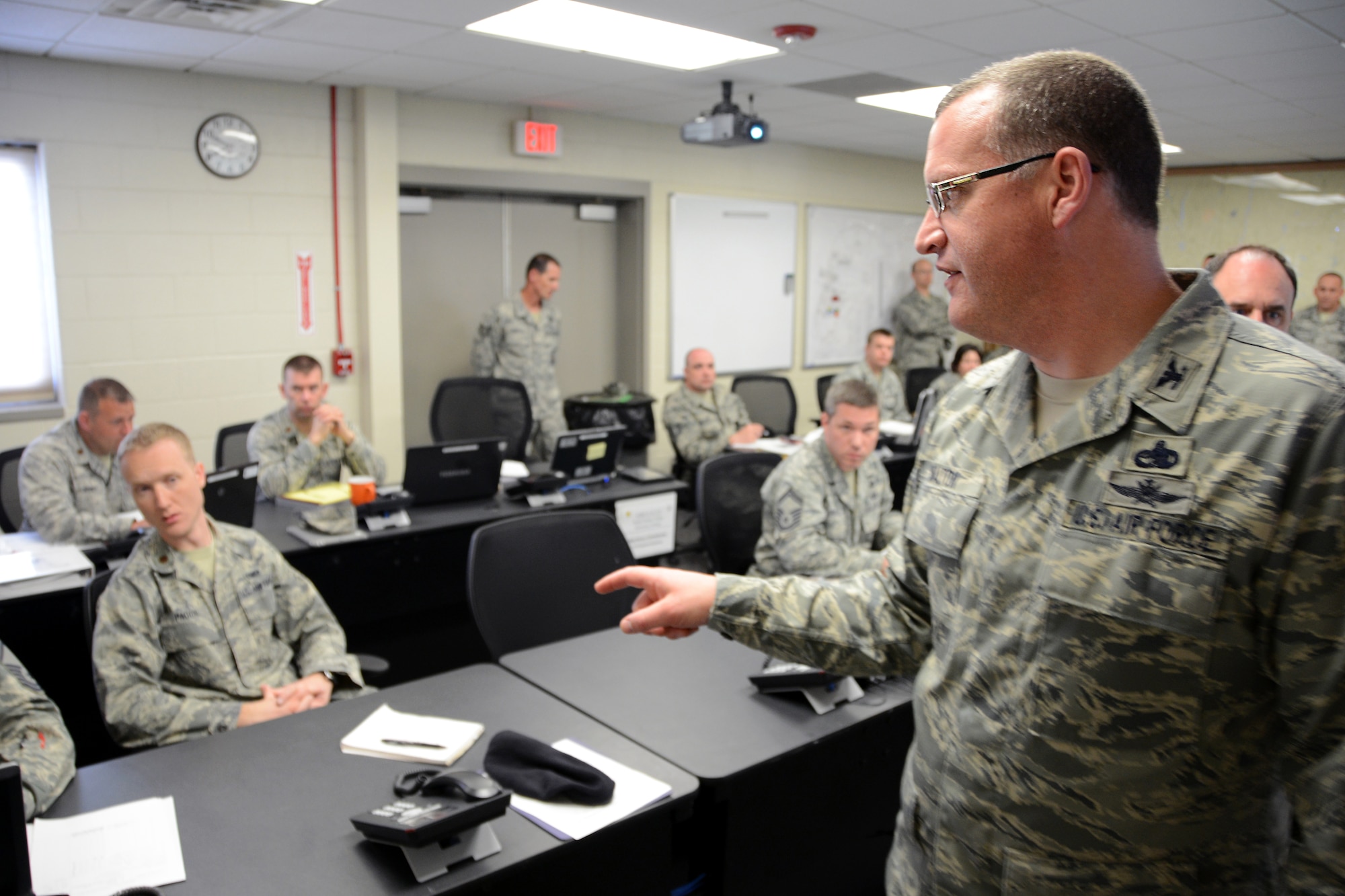Col. Roy Walton, commander of the 103rd Mission Support Group, walks around the emergency operations center directing individual subject matter experts during a table-top exercise on May 4, 2014, Bradley Air National Guard Base in East Granby, Conn. The exercise was designed to prepare the Connecticut Air National Guard for the upcoming hurricane season, and implement procedural changes and lessons learned from previous exercises and actual emergency response operations. (U.S. Air National Guard photo by Tech. Sgt. Joshua Mead)