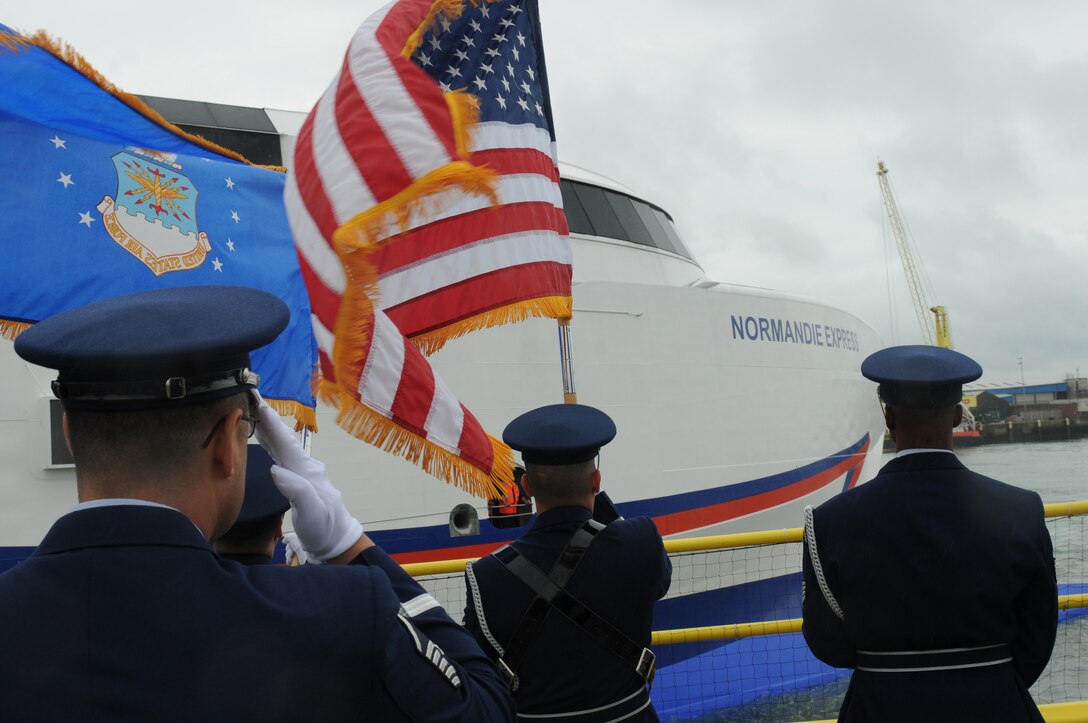 Honor Guard members from 422nd and 423rd Air Base Group of the 501st Combat Support Wing render a ceremonial salute for the U.S. D-Day veterans as they take part in the 70th anniversary of the invasion by journeying to Normandy from Portsmouth, United Kingdom, June 3, 2014. A series of events commemorating the 70th anniversary were planned for the week with many U.S. leaders travelling to the famous beaches to pay their respects to those who lost their lives. (U.S. Air Force photo by Tech. Sgt. Chrissy Best)