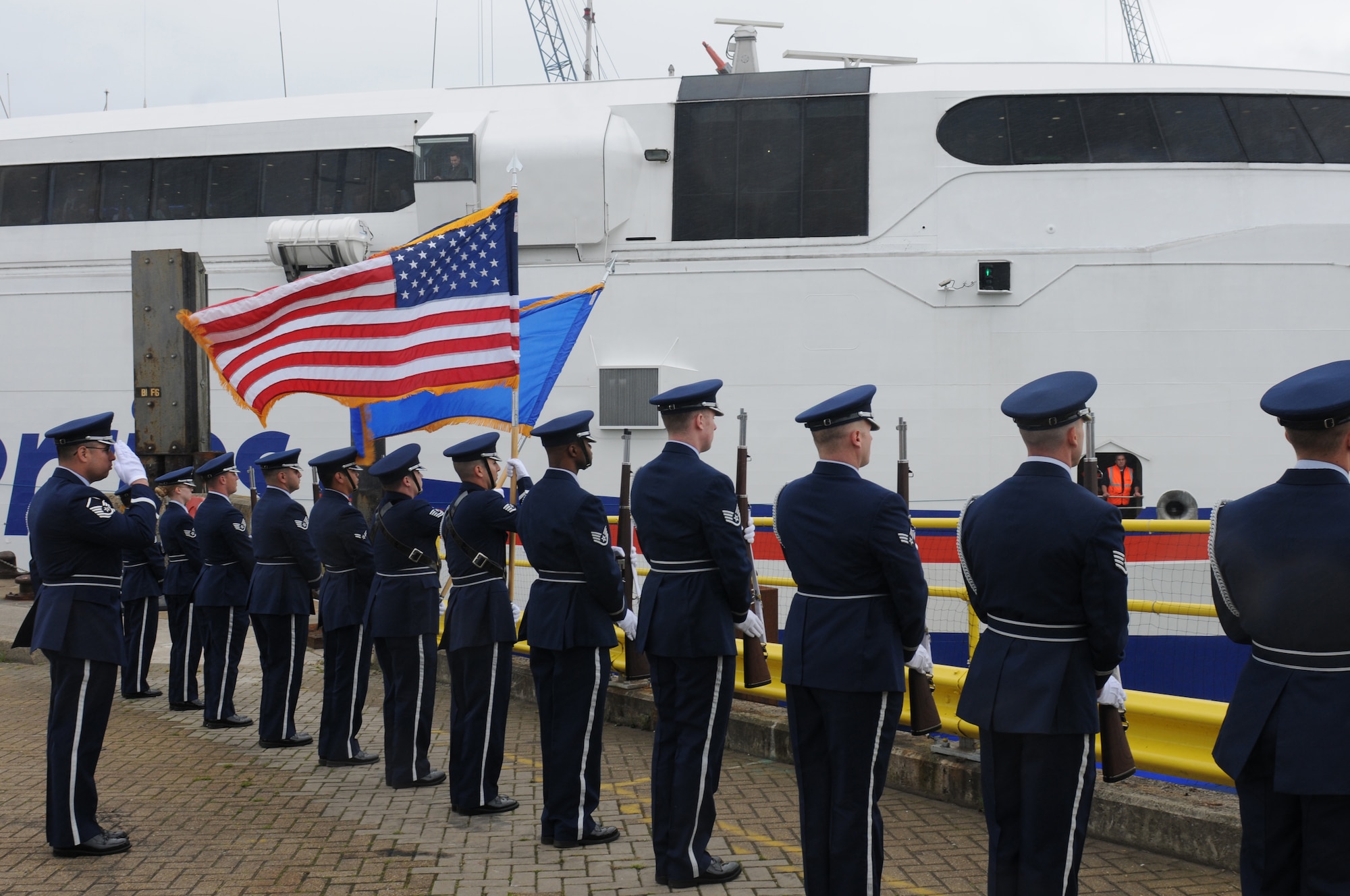 Honor Guard members from 422nd and 423rd Air Base Group of the 501st Combat Support Wing render a ceremonial salute for the U.S. D-Day veterans as they take part in the 70th anniversary of the invasion by journeying to Normandy from Portsmouth, United Kingdom, June 3, 2014. A series of events commemorating the 70th anniversary were planned for the week with many U.S. leaders travelling to the famous beaches to pay their respects to those who lost their lives. (U.S. Air Force photo by Tech. Sgt. Chrissy Best)