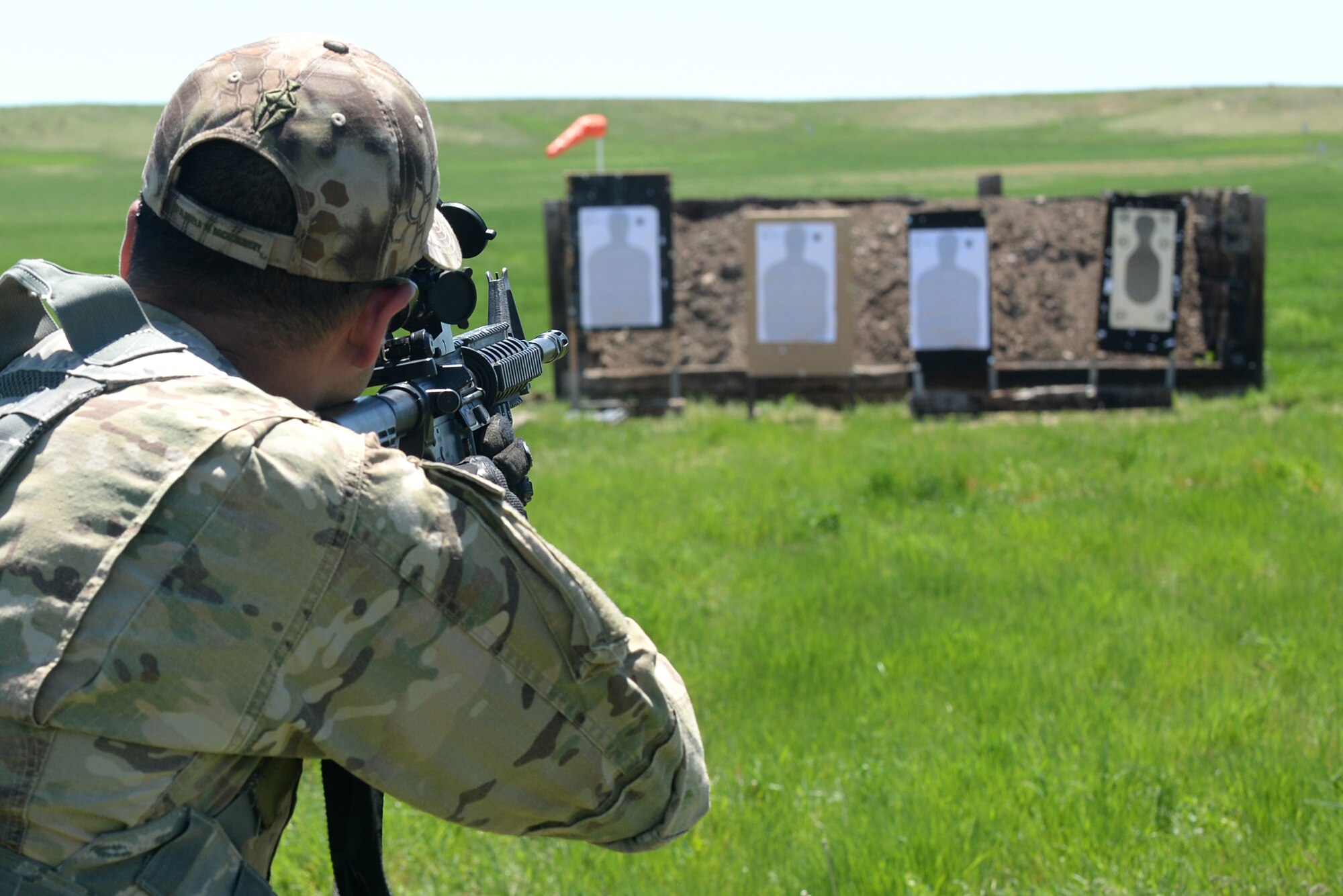 Staff Sgt. Edgar Cerrillo, 28th Security Forces Squadron unit orientation training instructor fires a M-4 Carbine rifle, during a qualification course at an outdoor shooting range in Rapid City, S.D., May 29, 2014. The training focused on extreme marksmanship, mental and physical fitness as well as tactical engagement and agility. (U.S. Air Force photo by Airman 1st Class Rebecca Imwalle/ Released)