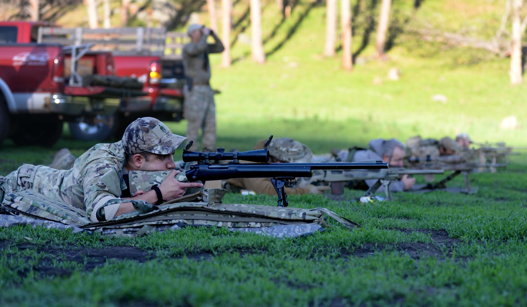 Staff Sgt. Edgar Cerrillo (left), 28th Security Forces Squadron unit orientation training instructor, undergoes sniper training with Rapid City/Pennington County special response team members at an outdoor shooting range in Rapid City, S.D., May 29, 2014. RC/PC SRT invited three 28th SFS Airmen to participate in the monthly SRT training in preparation for the South Dakota Advanced Sniper Course. (U.S. Air Force photo by Airman 1st Class Rebecca Imwalle/ Released)