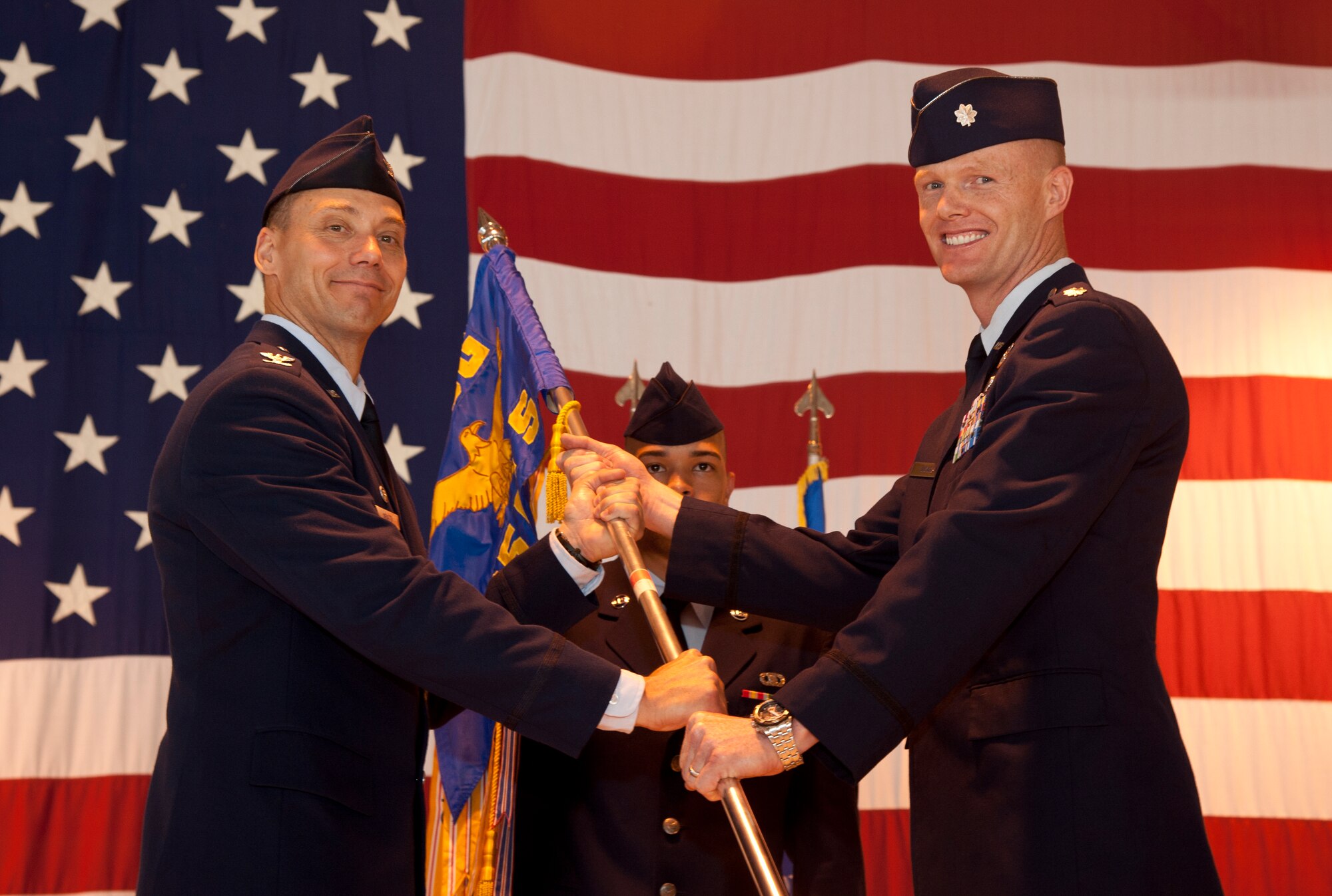 Lt. Col. Robert Vicars, the 25th Flying Training Squadron commander, takes the 25th FTS Guidon from Col. James Abatti, the 71st Operations Group commander during a change-of-command ceremony June 5 in Hangar 170 here. Vicars assumed command of the 25th Flying Training Squadron from Lt. Col. Jeffery Stands who is scheduled to retire June 6. (U.S. Air Force photo/Staff Sgt. James Bolinger)