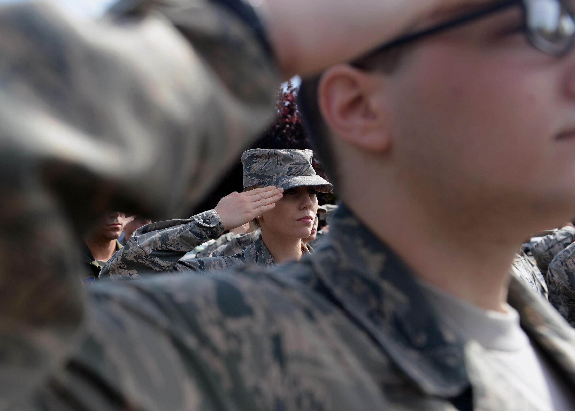 U.S. Air Force Airman 1st Class Jessie Moore, 100th Air Refueling Wing administrator from Dublin, Calif., salutes the U.S. flag as it’s lowered during the monthly retreat ceremony June 6, 2014, on RAF Mildenhall, England. A formation comprised of Airmen from the 100th Air Refueling Wing Staff Agencies, 100th OG and 727th Air Mobility Squadron paid their respects to the flag and ensign. (U.S. Air Force photo/Airman 1st Class Preston Webb/Released)