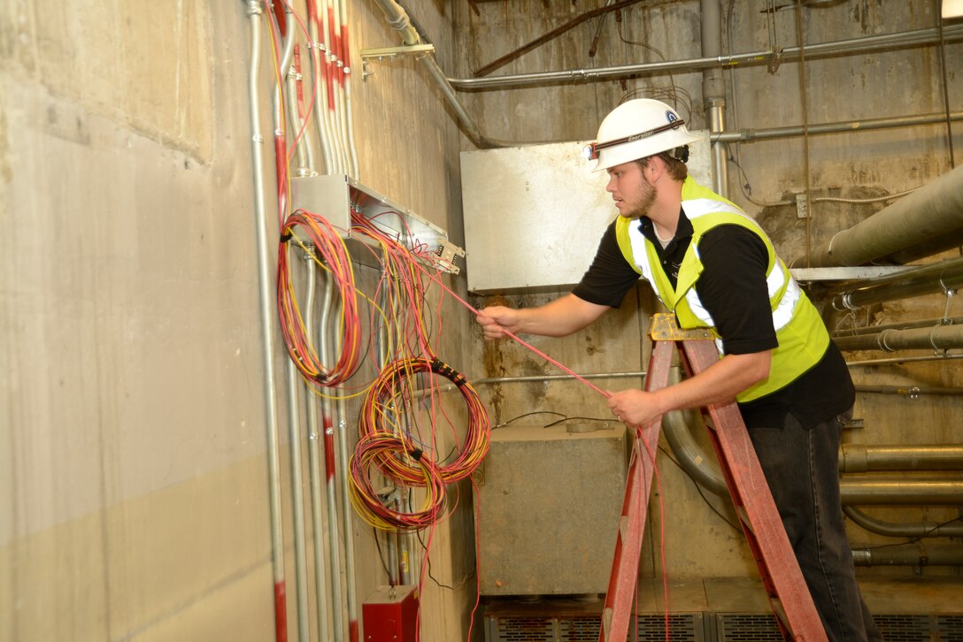 Gary Gilbert, electrician, pulls new wiring through the recently updated electrical conduit. After being dormant for many years, the Alert Facility is primed for a new life and mission. The renovation project is a multi-command and multi-agency effort.
U.S. Air Force photo by Ed Aspera