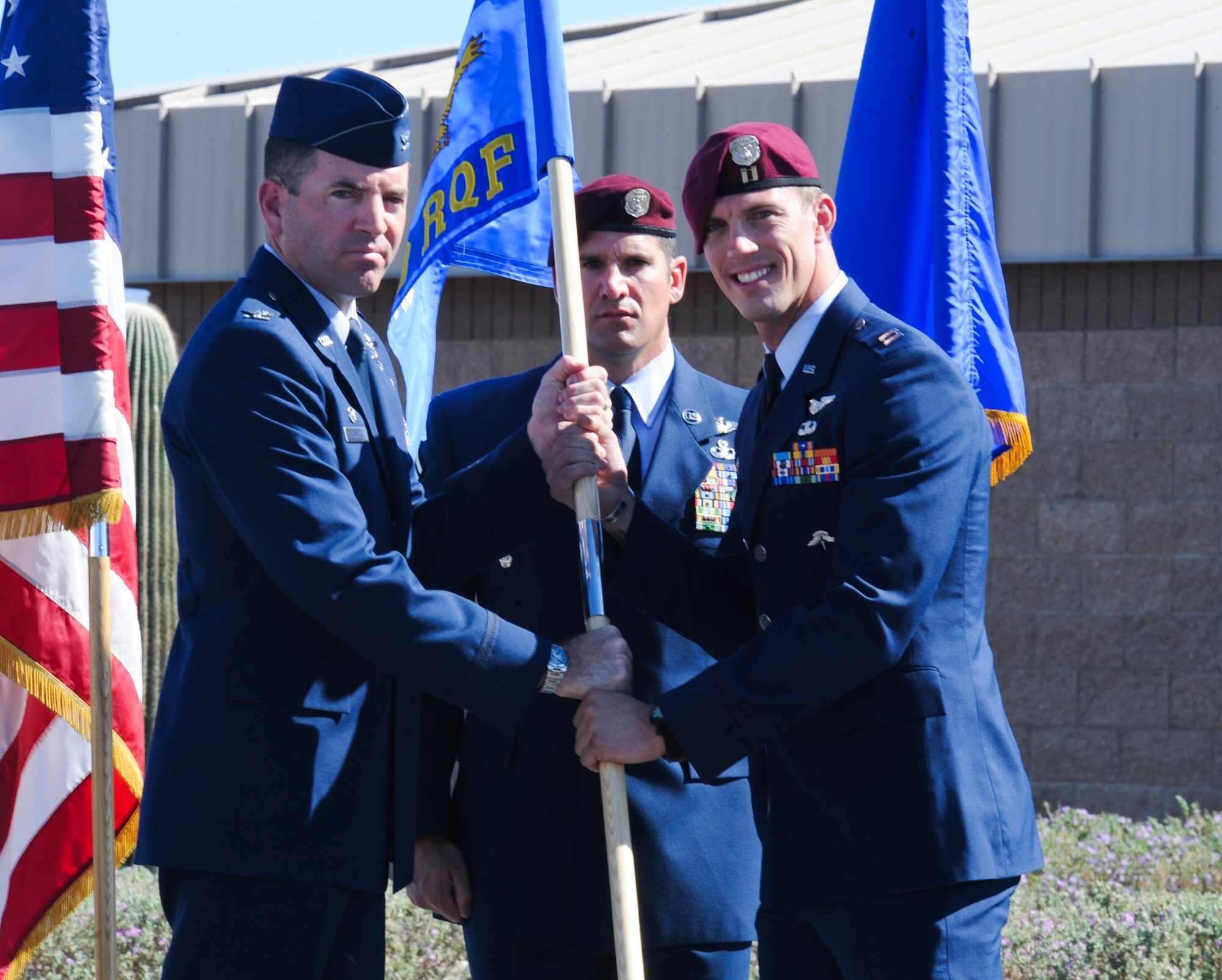 U.S. Air Force Col. Sean Choquette, 563rd Rescue Group commander, gives Capt. Michael Ellingsen, newly appointed 68th Rescue Flight commander, the guidon during an assumption of command ceremony at Davis-Monthan Air Force Base, Ariz., June 4, 2014. The 68th Rescue Flight’s mission is to instruct and train U.S. Air Force combat rescue officers and pararescuemen in advanced skill upgrades and proficiency training. (U.S. Air Force photo by Senior Airman Sivan Veazie/Released)