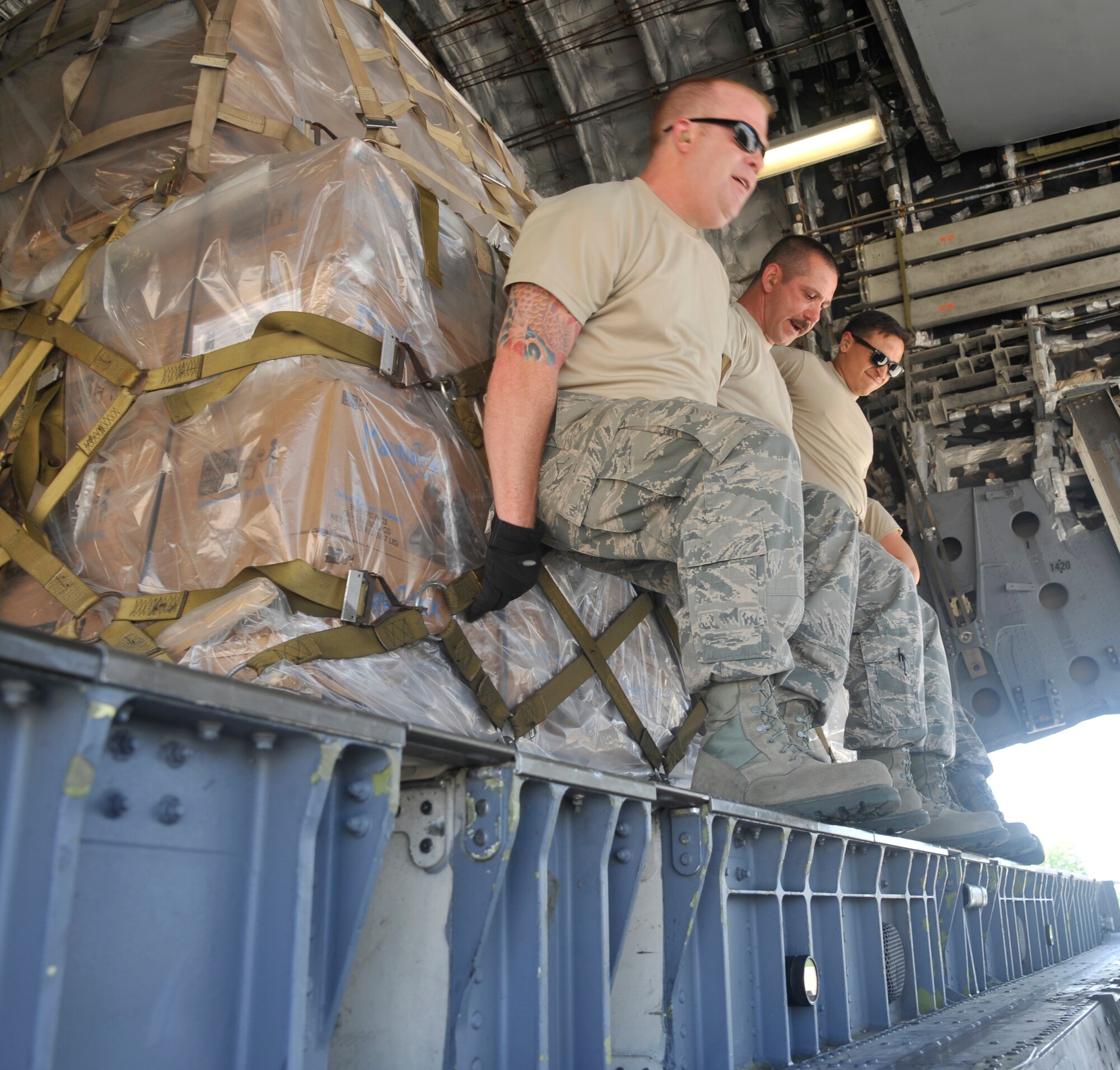 U.S. Air Force Airmen of the 509th Logistics Readiness Squadron, load cargo onto a C17 Globemaster III at Whiteman Air Force Base, Mo., May 10, 2014. This humanitarian move was en route to Haiti via Convoy of Hope from Springfield, Mo. The cargo contained rice and soybean. (U.S. Air Force photo by Airman 1st Keenan Berry/Released)