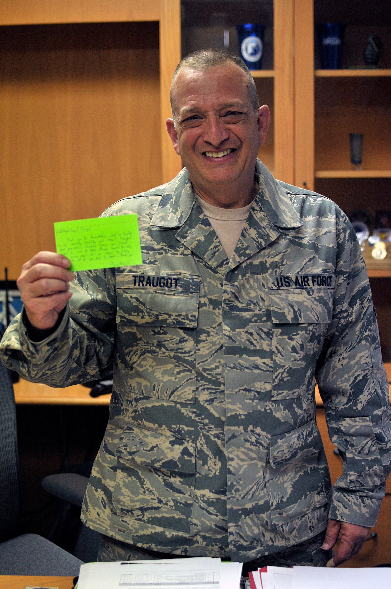 MCGHEE TYSON AIR NATIONAL GUARD BASE, Tenn. - Chief Master Sgt. Andrew Traugot, chief of TEC's Media and Engagement Division, holds up a "green card" he received from a Civil Air Patrol cadet for his lesson on supervision and discipline, June 4, 2014,  here at the I.G. Brown Training and Education Center. TEC's facility, instructors and staff supported the Southeast Region CAP's week-long training event. (U.S. Air National Guard photo by Master Sgt. Mike R. Smith/Released)