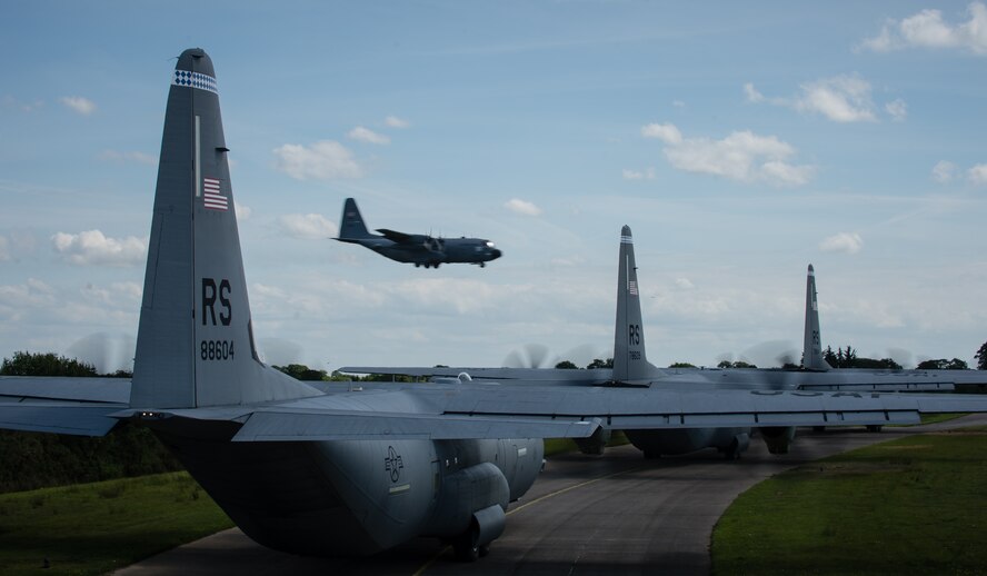Three C-130J Super Hercules aircraft line the runway waiting to taxi in Cherbourg, France, June 5, 2014. More than 60 Ramstein Airmen have traveled to Normandy, France to celebrate and honor the sacrifices made by veterans of World War II. (U.S. Air Force photo/Airman 1st Class Jordan Castelan)