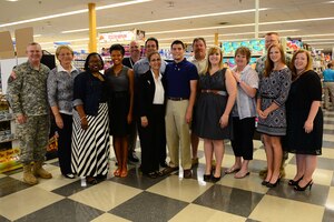 Local students receive scholarships from the Fisher House Foundation at the Commissary at Fort Eustis, Va., June 5, 2014. More than 11 million dollars has been awarded to students of military families in the last 13 years through the Scholarships For Military Children Program. (U.S. Air Force photo by Airman 1st Class Kimberly Nagle/Released)