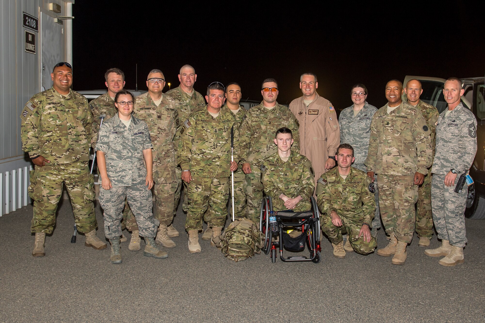 U.S. Air Force Tech. Sgt. Sarah Gann, 386th Air Expeditionary Wing protocol office, poses for a photo with six wounded warrior soldiers, their escorts, and base leadership before they leave for Afghanistan May 28, 2014 at an undisclosed location in Southwest Asia. The wounded warriors are part of Operation Proper Exit which gives them the opportunity to obtain closure and aid in their recoveries from injuries, internal and external, sustained on the battlefield. Gann is a Guardsman from the 144th Force Support Squadron, Fresno, California and deployed here in support of Operation Enduring Freedom. (U.S. Air Force photo by Staff Sgt. Jeremy Bowcock)