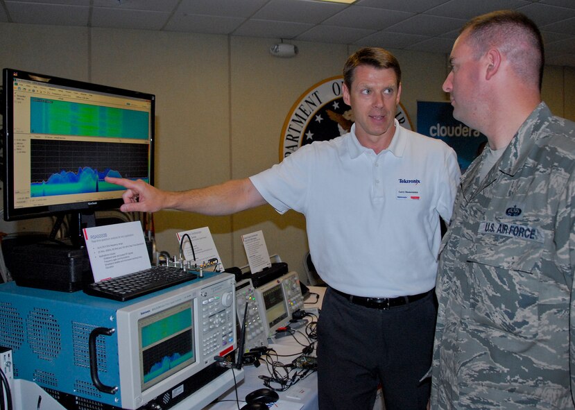 Staff Sgt. Cedar McQuigg, of the 96th Communications Squadron, receives a demonstration on a real time signal analyzer from Larry Shemetulskis, technical sales account manager with Tektronix-Keithley, a test and measurement equipment design company, at the Technology Expo, at Eglin Air Force Base, Fla. June 5.  More than 30 exhibitors from across the United States offered information and displays about the latest defense technologies; storage solutions; and logistical and engineering services, among other technologies.  (U.S. Air Force photo/Kevin Gaddie)   