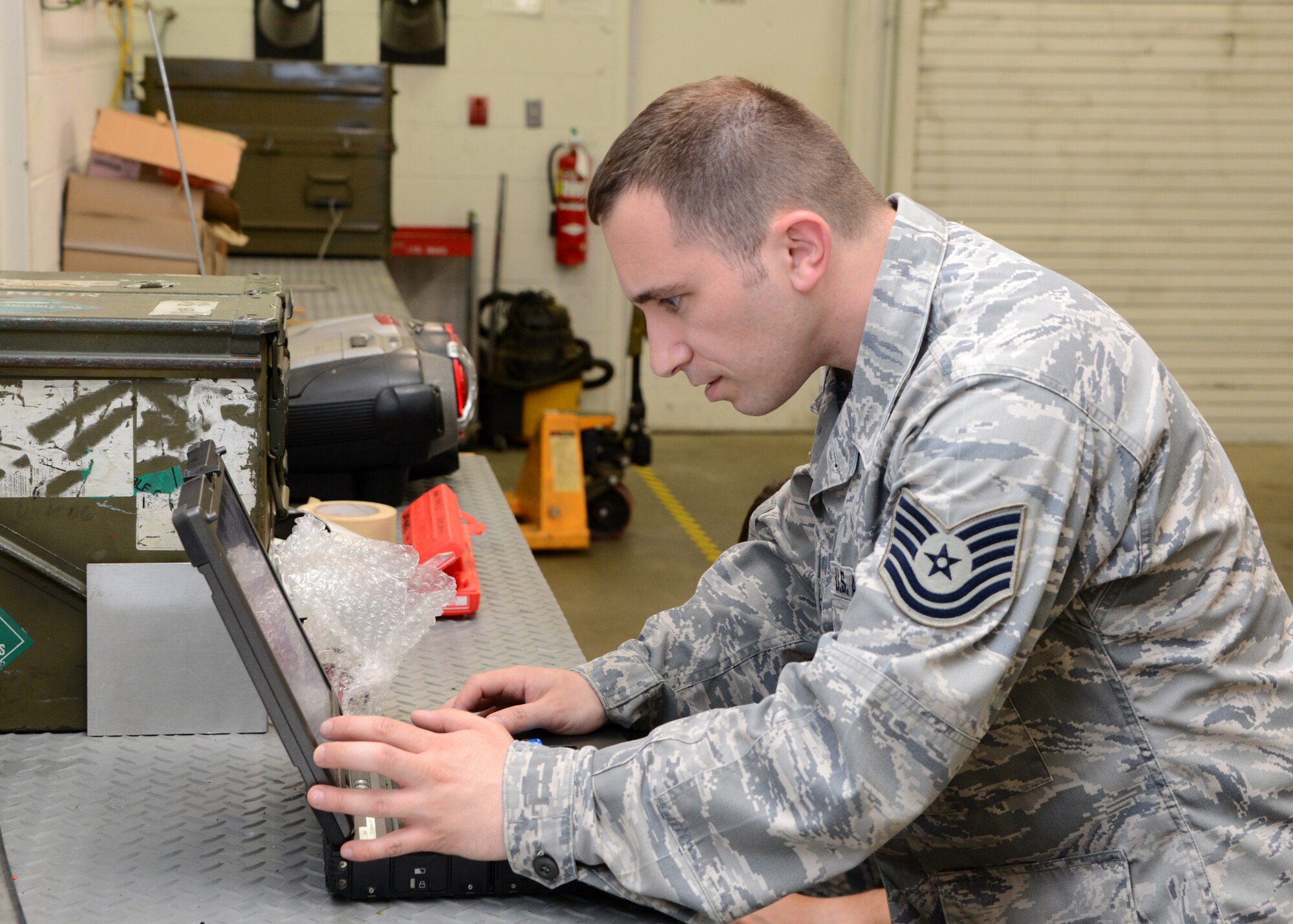 U.S. Air Force Tech. Sgt. Ilir Kojtari, 175th Maintenance Squadron precision guided munitions section non-commissioned officer in charge (NCOIC), 175th Wing Maryland Air National Guard, reviews a technical order during a training session with Senior Airman Adam Ahern, 175th Maintenance Squadron munitions specialist, at Warfield Air National Guard Base, Baltimore, Maryland, May 15, 2014.  Kojtari was training Ahern on the proper removal procedures for the Guidance Control Unit (GCS) of an AGM-65A missile.  (U.S. Air National Guard photo by Tech. Sgt. Christopher Schepers/RELEASED)