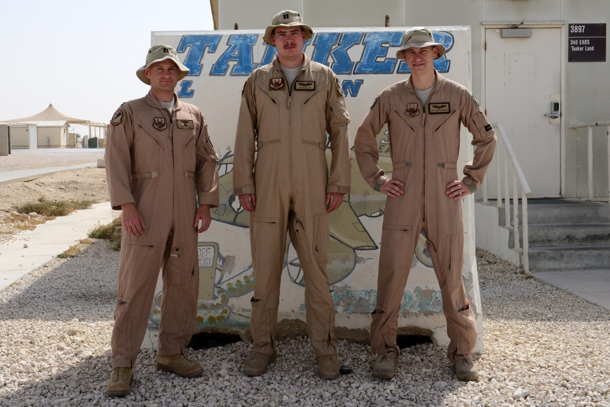 U.S. Air Force Captains Jonathan Walker, Christopher Miller and Staff Sgt. Jarrett Walker, 340th Expeditionary Air Refueling Squadron, pose for a photo at Al Udeid Air Base, Qatar, June 4, 2014. The three demonstrated wingmanship when a fellow flyer needed help communicating an in-flight emergency May 22. They are deployed from the 906th Air Refueling Squadron, Scott Air Force Base, Illinois. (U.S. Air Force photo by Staff Sgt. Ciara Wymbs)  