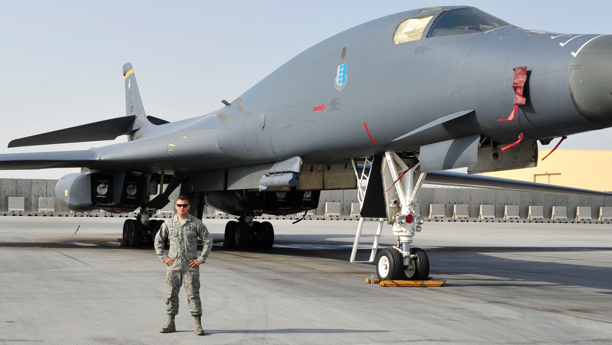 U.S. Air Force Staff Sgt. David Baker, 379th Expeditionary Aircraft Maintenance Squadron B-1 crew chief, poses next to a B-1B Lancer at Al Udeid Air Base, Qatar, May 21, 2014. Baker is one of 35 crew chiefs maintaining the aircraft deployed from Ellsworth Air Force Base, South Dakota. Baker’s home station is Ellsworth Air Force Base, South Dakota, and his hometown is Rochester, New York.  (U.S. Air Force photo by Senior Airman Colin Cates) 