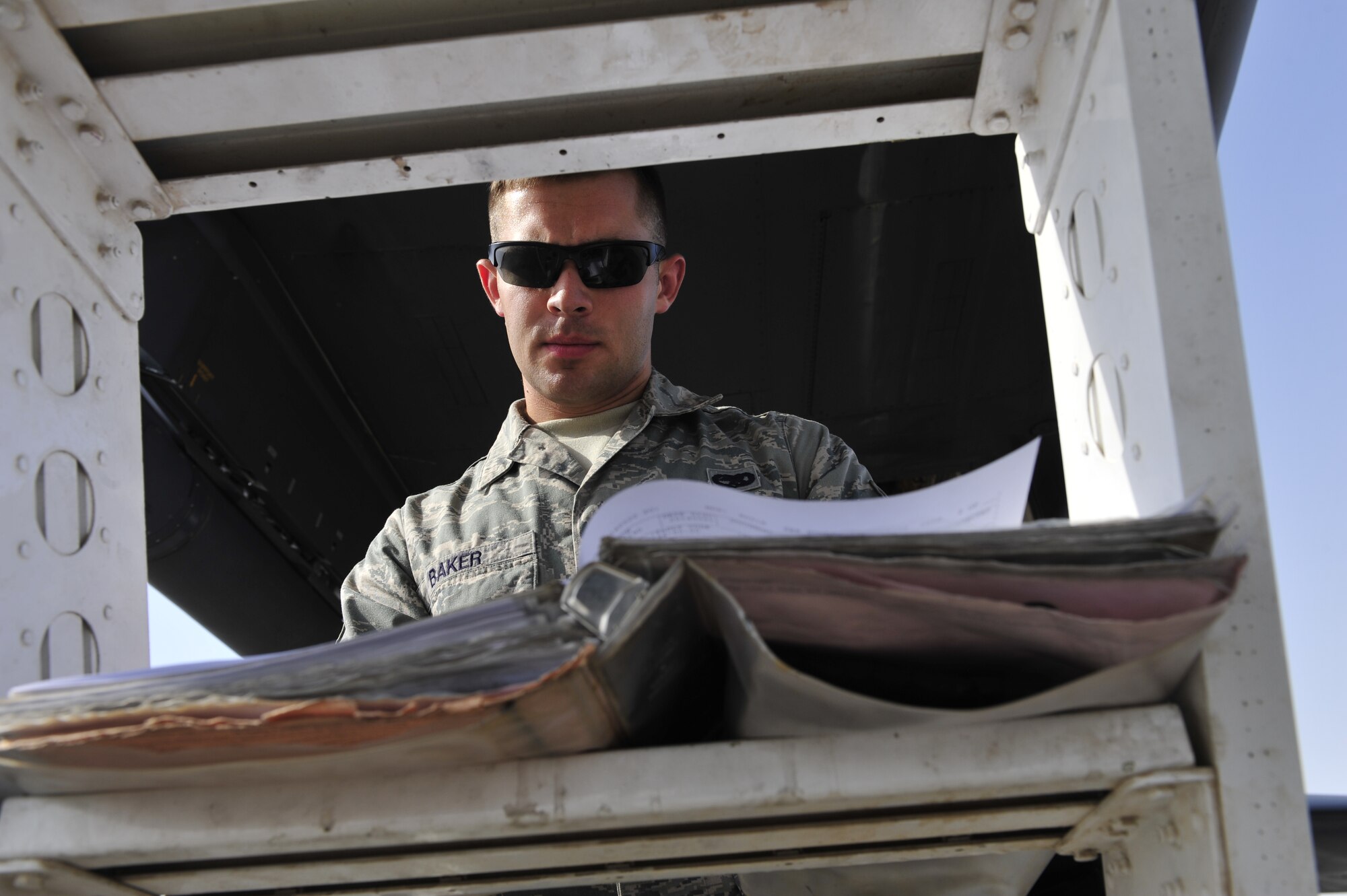 U.S. Air Force Staff Sgt. David Baker, 379th Expeditionary Aircraft Maintenance Squadron crew chief, reviews the accountability binder for a B-1 Lancer at Al Udeid Air Base, Qatar, May 21, 2014. Baker is required to check all service inspections on his B-1 and to ensure that it is capable of flying. Baker’s home station is Ellsworth Air Force Base, South Dakota, and his hometown is Rochester, New York. (U.S. Air Force photo by Senior Airman Colin Cates)