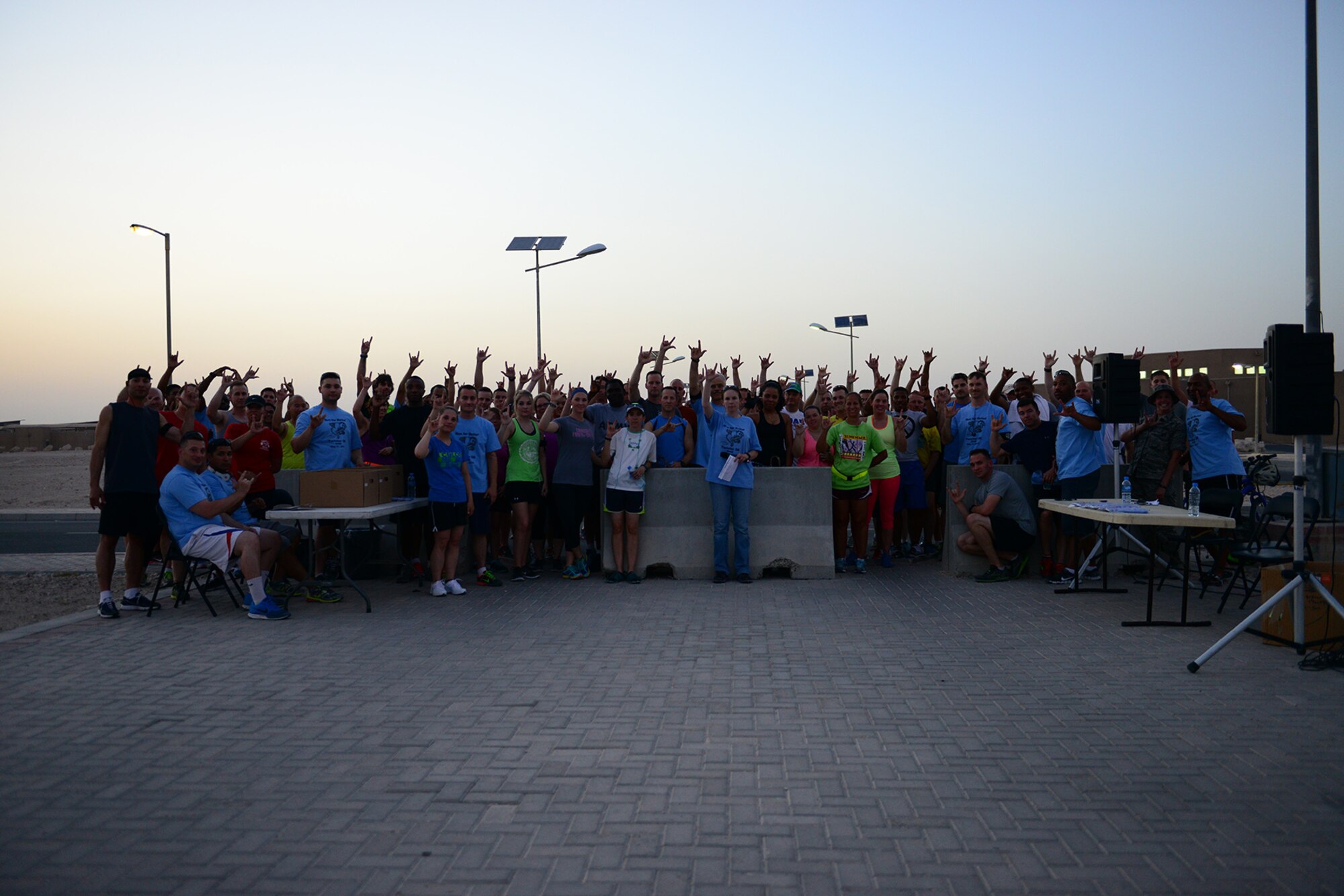 U.S. Air Force Airmen demonstrate “I love you” in American Sign Language at Al Udeid Air Base, Qatar, May 31, 2014. The Airmen came together to raise money for the American Red Cross and for those affected by the recent Arkansas tornadoes. (U.S. Air Force photo by Staff Sgt. Ciara Wymbs) 