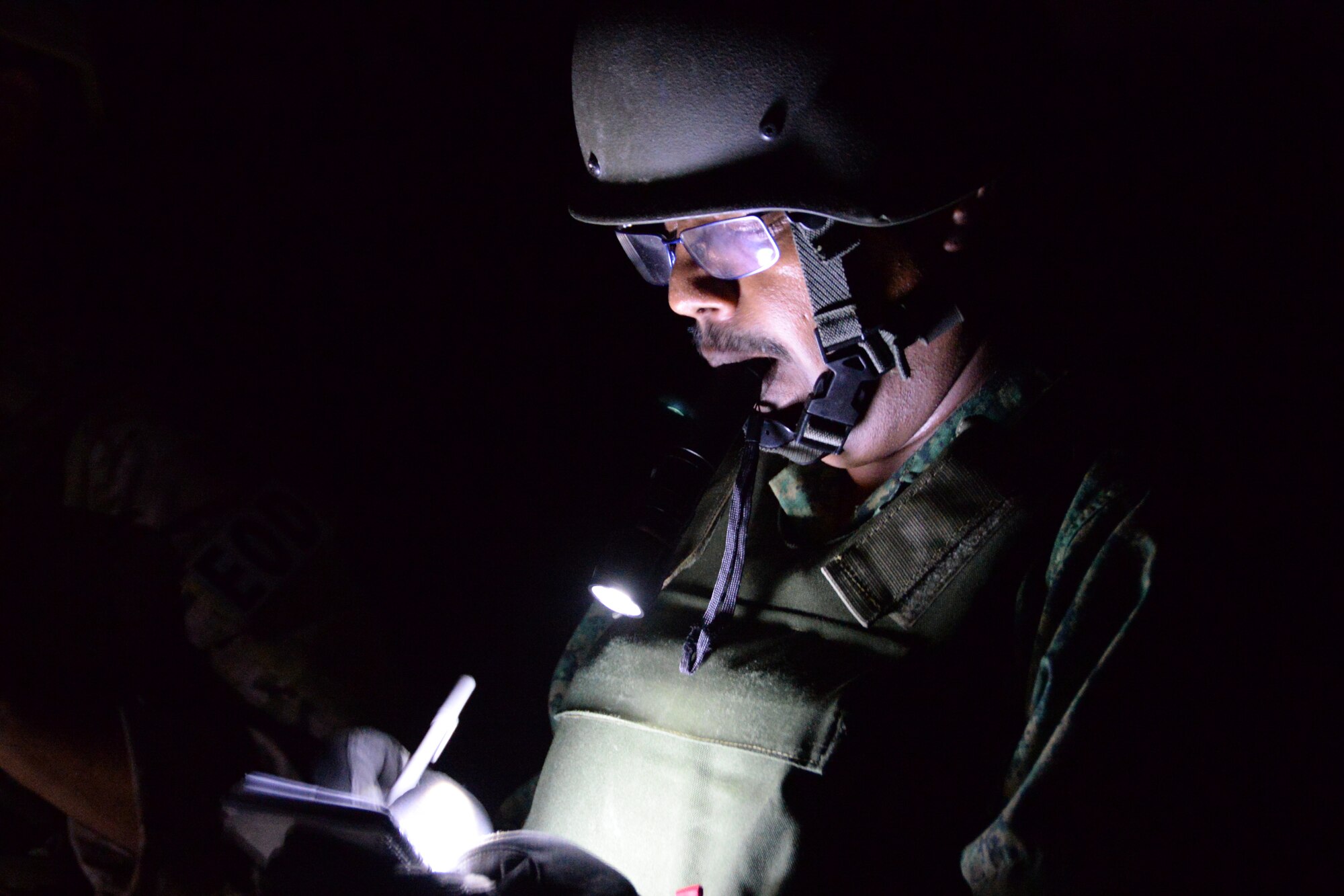 Singapore Military Expert 3 Saravanan Sammugam, explosive ordnance disposal technician, reviews notes during a training scenario for Exercise Tri-Crab May 5, 2014, on Naval Base Guam. Tri-Crab is a biennial, multinational EOD exercise designed to reinforce skillsets and strengthen interoperability among Australia, Singapore, and the United States. (U.S. Air Force photo by Airman 1st Class Amanda Morris/Released) 