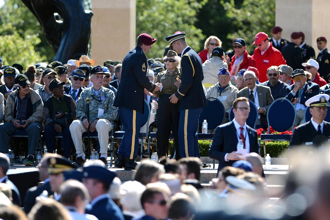 U.S. Defense Secretary Chuck talks with a World War II veteran at the Normandy American Cemetery during a ceremony commemorating the 70th anniversary of D-Day in Normandy, France, June 6, 2014.  