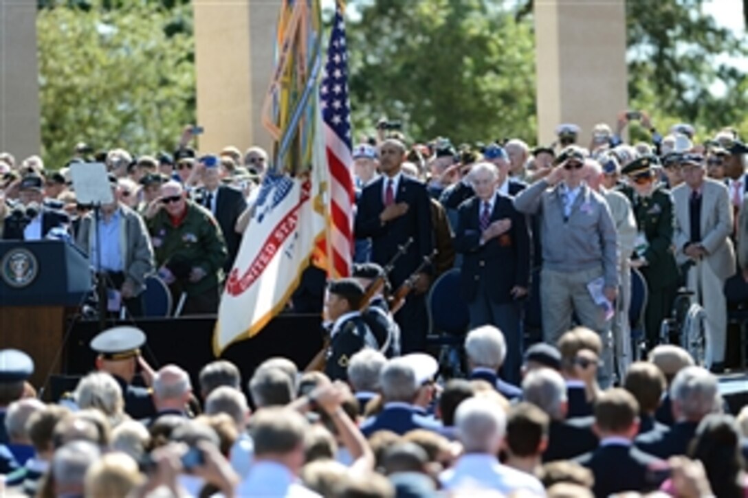 U.S. President Barack Obama and World War II veterans render honors as the U.S. Army Color Guard presents its colors at the Normandy American Cemetery during the 70th anniversary of D-Day in Normandy, France, June 6, 2014.  