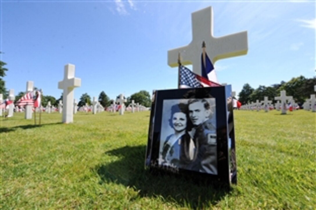 A headstone with a photo of a loved one is displayed in the Normandy American Cemetery during the 70th Anniversary of D-Day in Normandy, France, June 6, 2014.