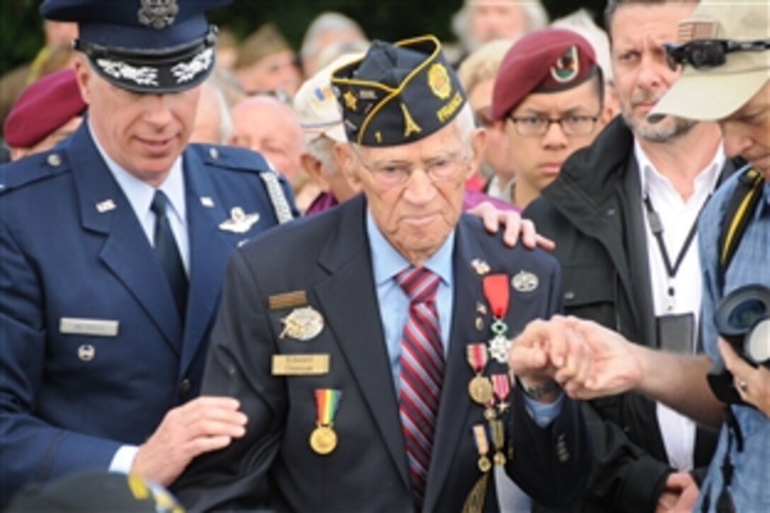 A World War II veteran takes his seat during a ceremony to commemorate the Troop Carriers of the 9th Air Force in Picauville, France, June 5, 2014. Paratroopers of the 4th Infantry Brigade Combat Team (Airborne), 25th Infantry Division are in France as a part of Task Force Normandy 70 to assist with multiple ceremonies commemorating the historic event and honoring those who fought in it.  