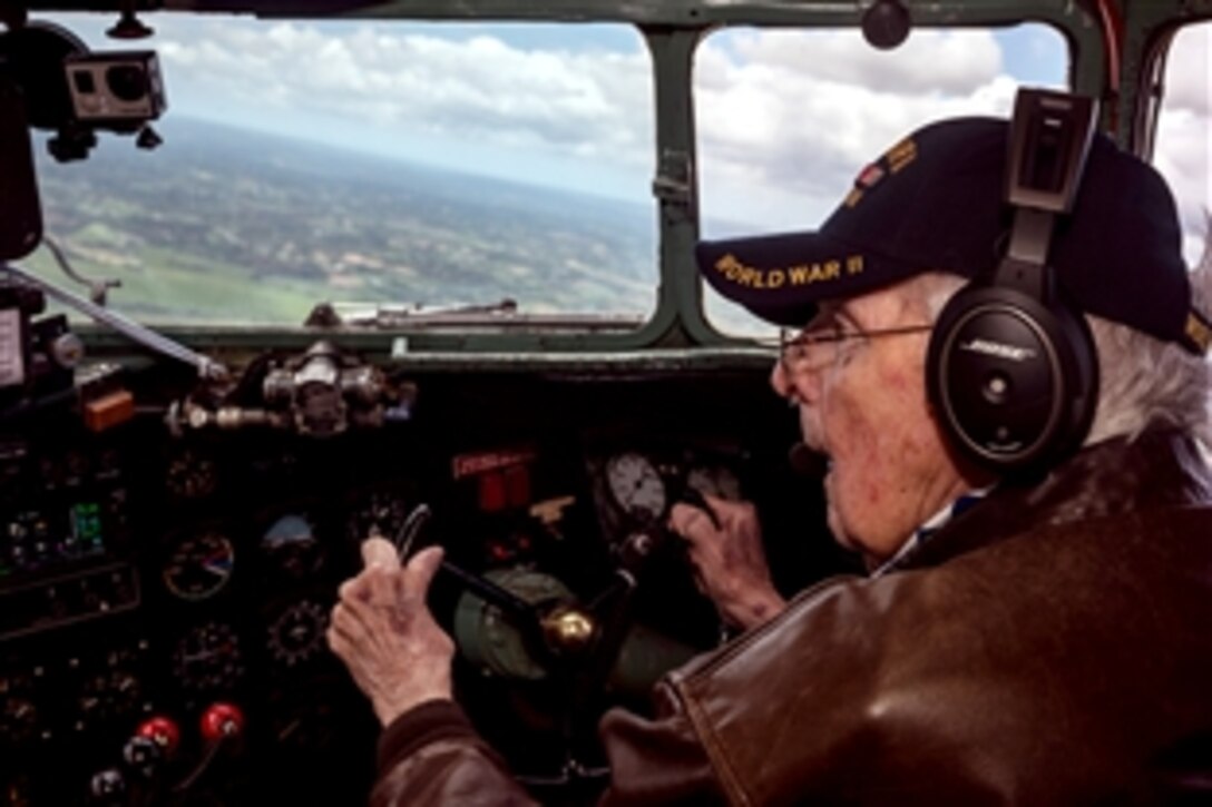Bill Prindible, a veteran U.S. Army pilot who flew on D-Day, takes the controls of a C-47 Skytrain during a commemorative flight over Normandy, France, June 5, 2014, as part of a series of D-Day 70th anniversary activities. 