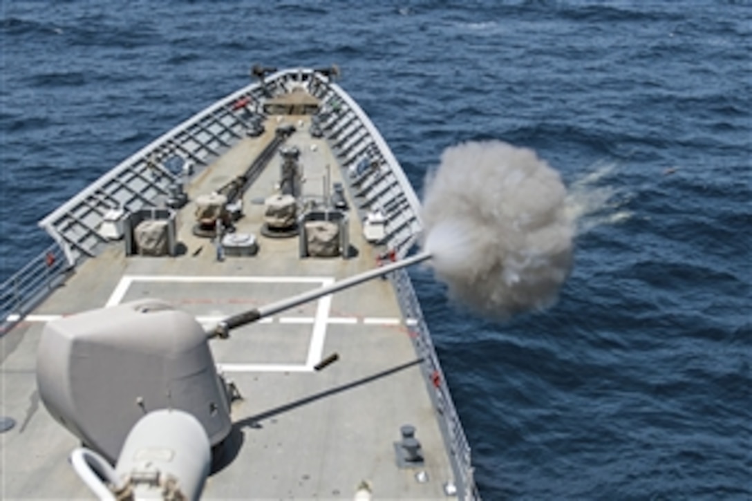 The crew aboard the USS Philippine Sea fires its 5-inch Mk-45 lightweight gun during a live-fire exercise in the Arabian Sea, June 1, 2014. The Philippine Sea is deployed as part of the George H.W. Bush Carrier Strike Group supporting maritime security operations and theater security cooperation efforts in the U.S. 5th Fleet area of responsibility. 