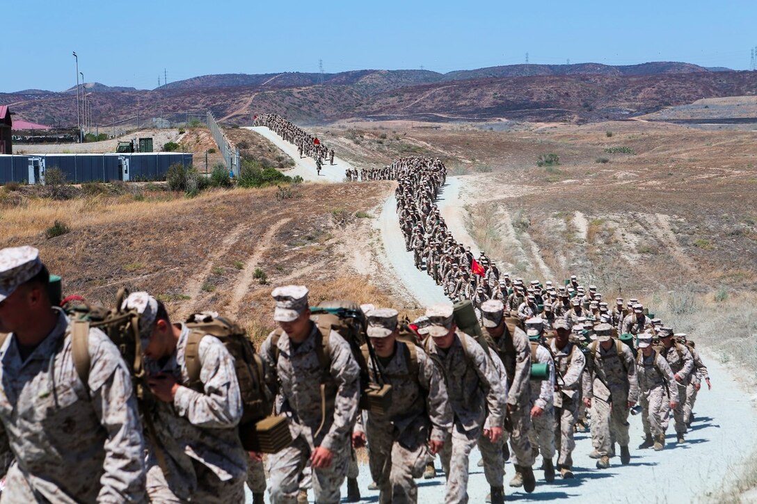 Marines with 1st Light Armored Reconnaissance Battalion, 1st Marine Division, I Marine Expeditionary Force hike nearly 5 miles from Camp Las Flores to Red Beach aboard Camp Pendleton, Calif., Jun 5, 2014.   Upon arrival at Red Beach, 1st LAR held the annual Highlander Games Warrior Night, a battalion tradition with the purpose of building unit camaraderie and esprit de corps. 