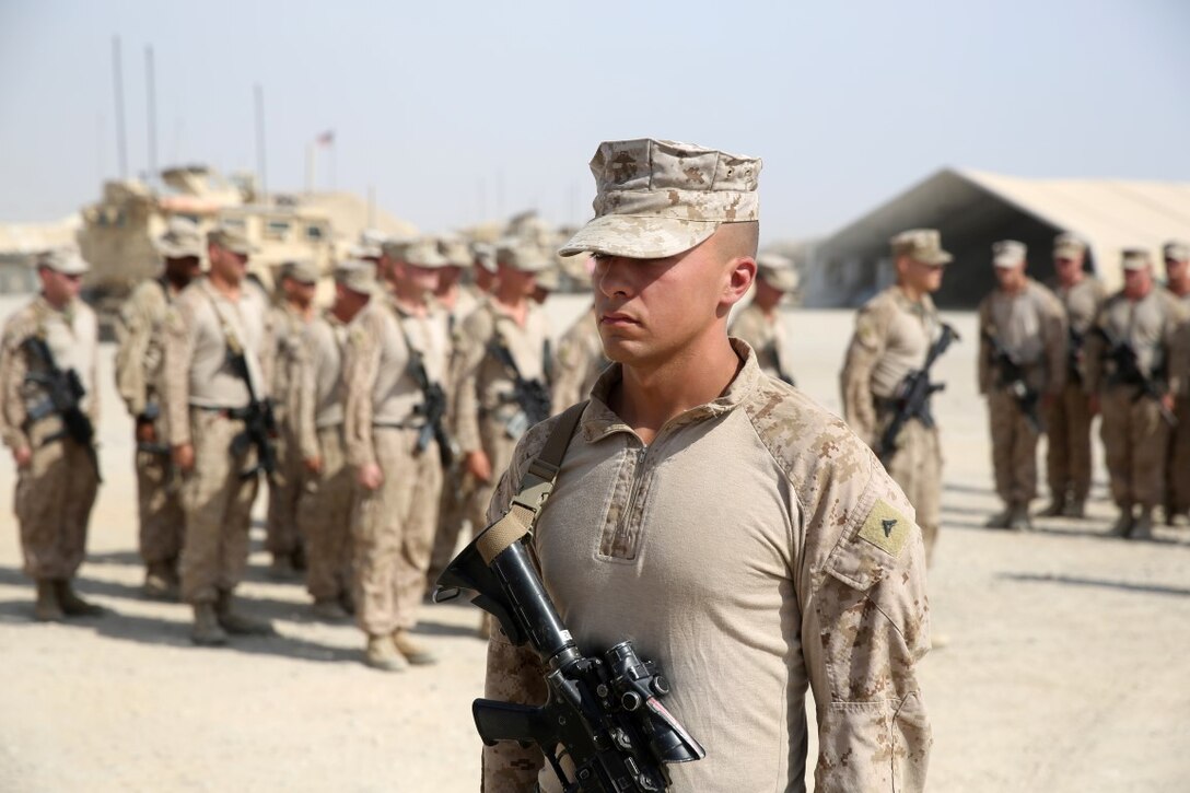 Corporal Jonathan Hollis, a native of Grand Rapids, Michigan, stands at attention before being combat meritoriously promoted to corporal aboard Camp Leatherneck, Afghanistan, June 2, 2014. Hollis, an anti-tank missileman with Weapons Co., is currently deployed to Helmand province, Afghanistan, in support of Operation Enduring Freedom.
 (U.S. Marine Corps photo by Cpl. Joseph Scanlan / released)