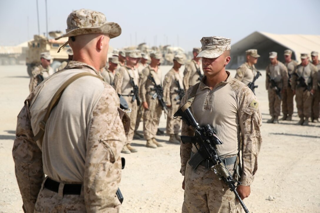 Corporal Jonathan Hollis, a native of Grand Rapids, Michigan, stands at attention before being combat meritoriously promoted to corporal aboard Camp Leatherneck, Afghanistan, June 2, 2014. Hollis, an anti-tank missileman with Weapons Co., is currently deployed to Helmand province, Afghanistan, in support of Operation Enduring Freedom.
 (U.S. Marine Corps photo by Cpl. Joseph Scanlan / released)