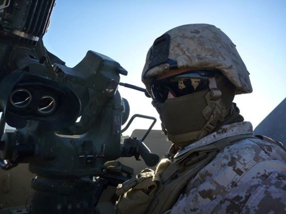 Lance Cpl. Jonathan Hollis, a native of Grand Rapids, Michigan, takes a photo with a mounted Tube-launched, Optically-tracked, Wire-guided missile system during a training exercise aboard Marine Corps Air Ground Combat Center Twentynine Palms, California. Hollis, an anti-tank missileman with Weapons Company, 1st Battalion, 7th Marine Regiment, is currently deployed to Helmand province, Afghanistan. He earned a combat meritorious promotion to corporal, June 2, 2014.