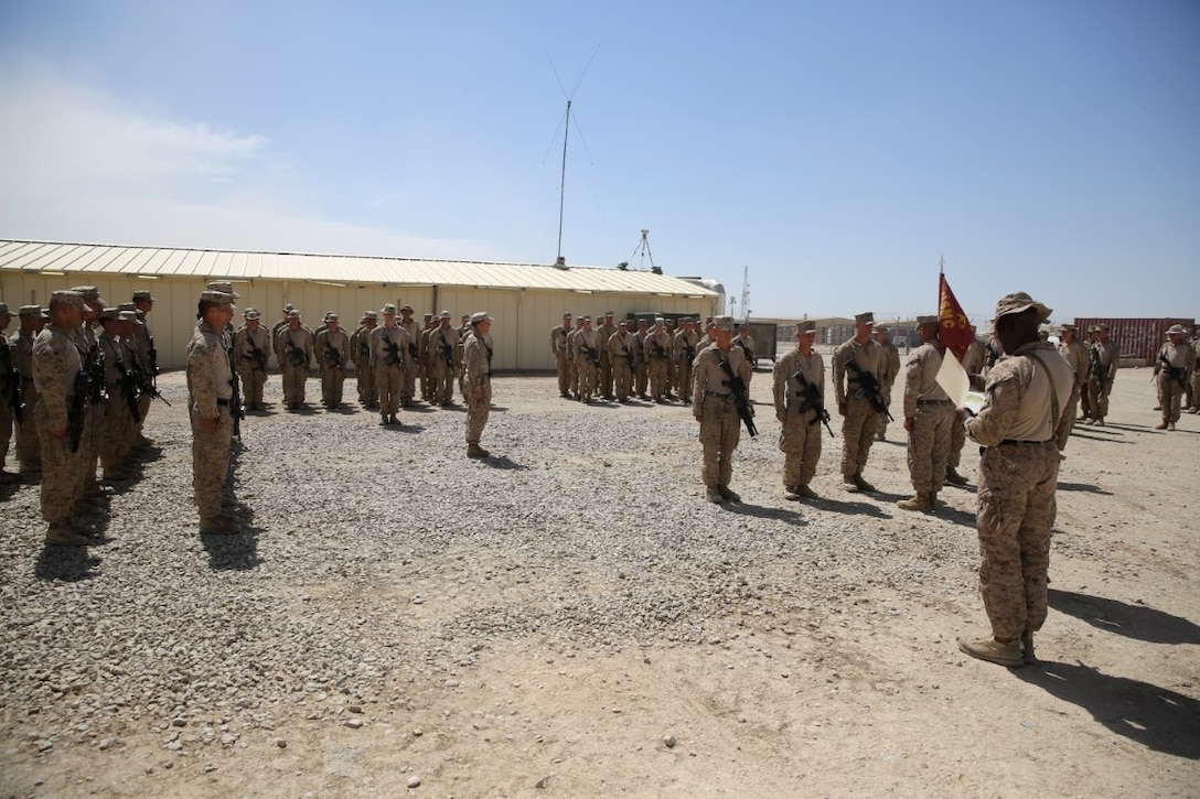 Marines with Weapons Company, 1st Battalion, 7th Marine Regiment, stand at attention during a promotion ceremony aboard Camp Leatherneck, Afghanistan, June 1, 2014. Twenty-eight Marines with the battalion were promoted to the ranks of corporal and sergeant, June 1 and 2. (U.S. Marine Corps photo by Cpl. Joseph Scanlan / released)
