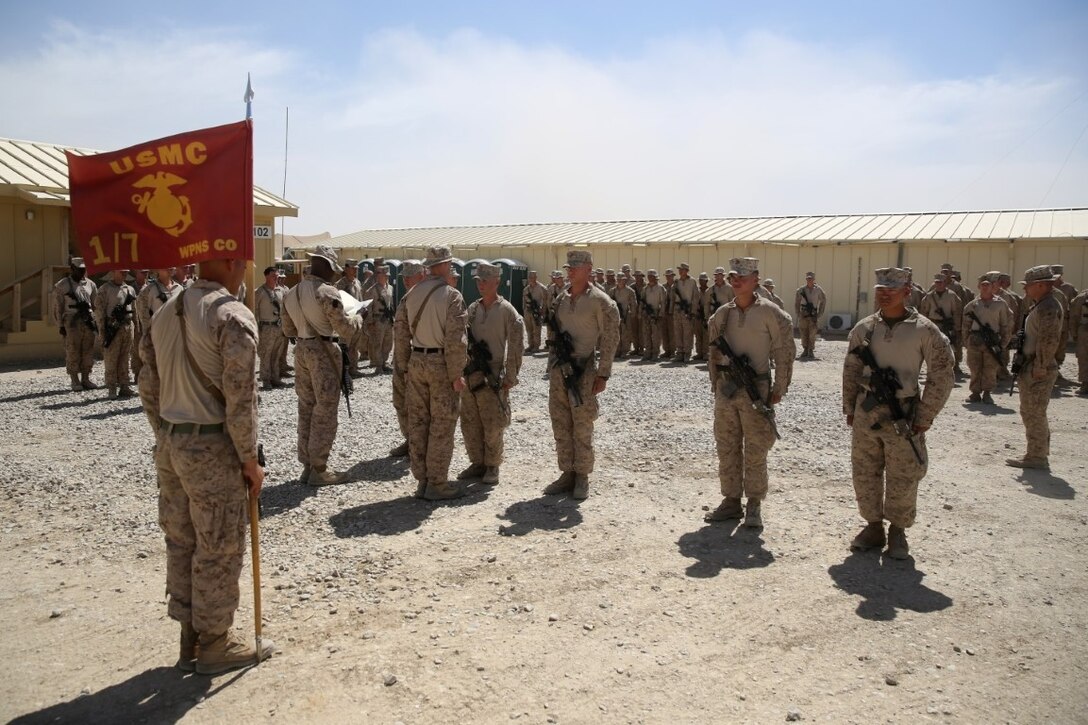 Marines with Weapons Company, 1st Battalion, 7th Marine Regiment, stand at attention before being promoted aboard Camp Leatherneck, Afghanistan, June 1, 2014. Twenty-eight Marines with the battalion were promoted to the ranks of corporal and sergeant, June 1 and 2. (U.S. Marine Corps photo by Cpl. Joseph Scanlan / released)