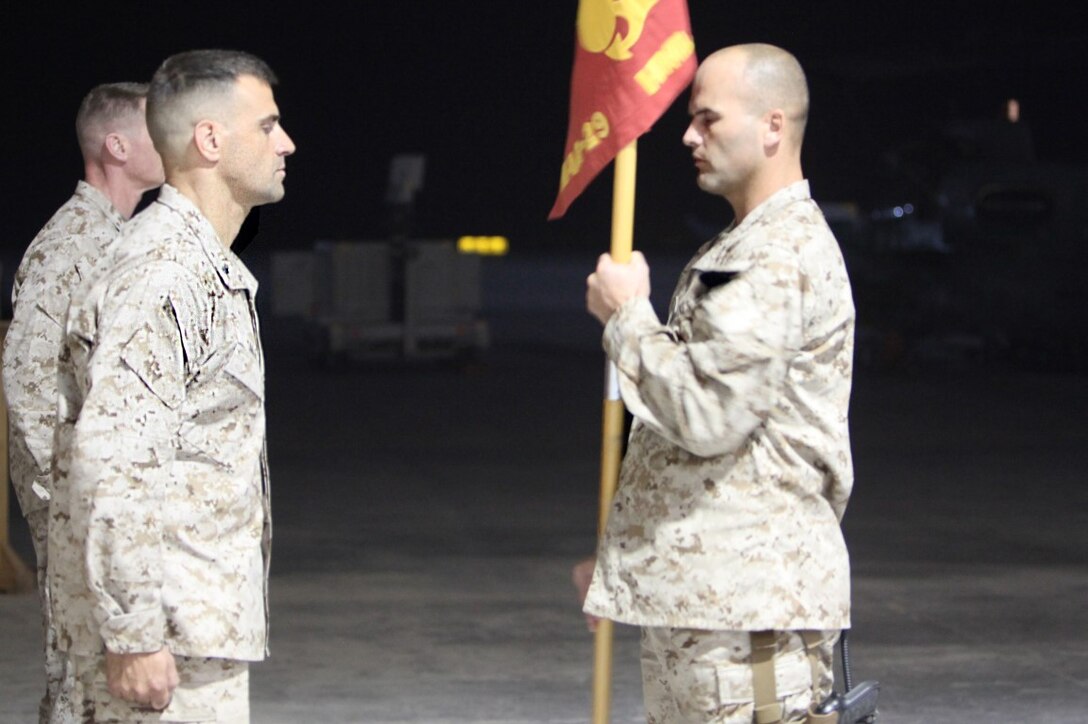 Lieutenant Col. Matthew Sale, left, commanding officer of Marine Light Attack Helicopter Squadron 467, prepares to receive the squadron's guidon from Sgt. Maj. John Kennedy, sergeant major of HMLA-467, signifying the transfer of authority from HMLA-369 during a midnight ceremony aboard Camp Bastion, Afghanistan, May 24, 2014. Marine Light Attack Helicopter Squadron 467 has only been a squadron for five years and is on its first combat deployment since its establishment. The Marines of HMLA-467, deployed from Marine Corps Air Station Cherry Point, North Carolina, are ready to take on the task of being the last HMLA to serve in Afghanistan. (U.S. Marine Corps Photo By: Sgt. Frances Johnson/Released)