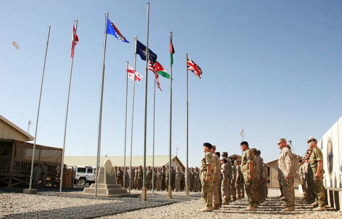 Service members with Regional Command (Southwest) stand at attention during a Memorial Day ceremony aboard Camp Leatherneck, Afghanistan, May 26, 2014. During the ceremony, RC(SW) Commander Brig. Gen. Daniel D. Yoo spoke about the importance of the day and service members observed a moment of silence to remember those who gave their lives in service to their country. (U.S. Marine Corps photo by Sgt. Jessica Ostroska/ Released)